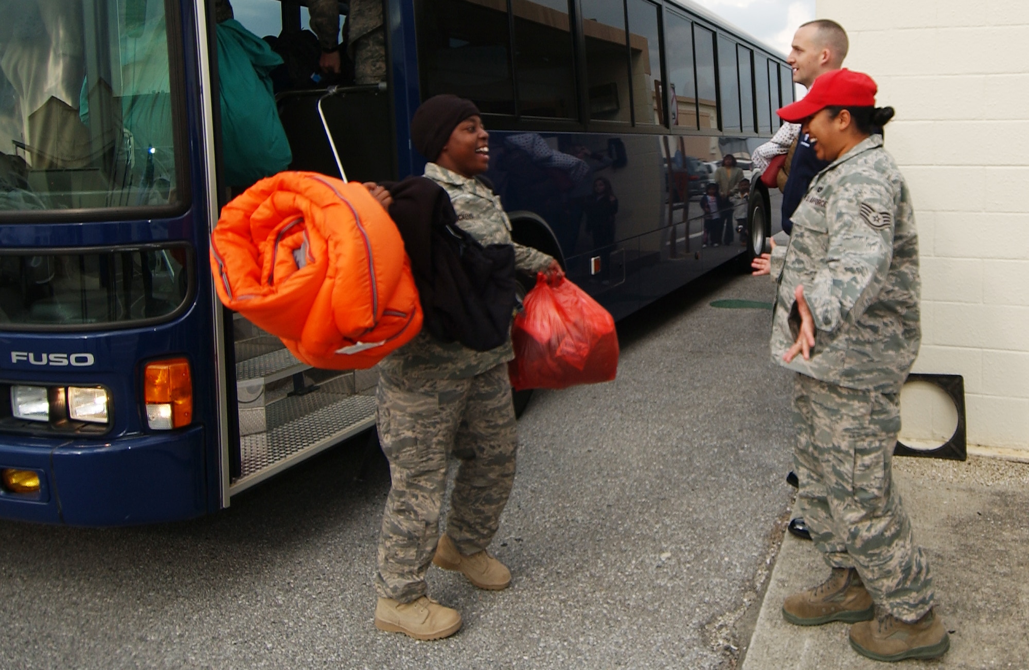 Airmen from the 33rd Rescue Squadron are welcomed home by friends, relatives and co-workers on Jan. 12 at Kadena Air Base, Japan. The 33rd Rescue Squadron returned from a three-month deployment to Afghanistan where they provided combat search and rescue support for U.S. and coalition operations.  (U.S. Air Force photo/Tech. Sgt. Rey Ramon)         