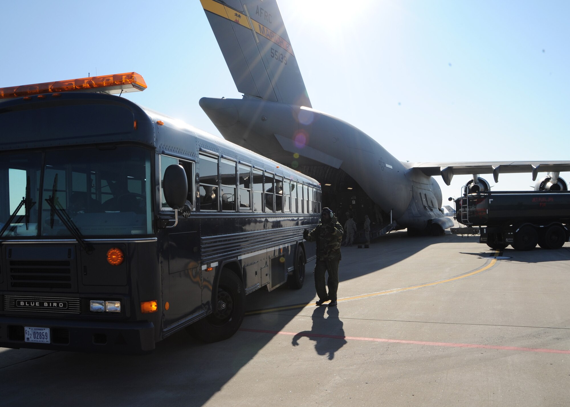 SCOTT AIR FORCE BASE, Ill. -- A bus from the 375th Medical Group Aeromedical Staging Facility backs up to a waiting C-17 on which wounded warriors flew home on the final leg of their journeys Saturday. About 50 patients came through Scott during the weekend, which was about double the normal patient load. The influx came as a result of closed airspace around the national capitol region during the presidential inauguration. (U.S. Air Force photo/Airman 1st Class Wesley Farnsworth)