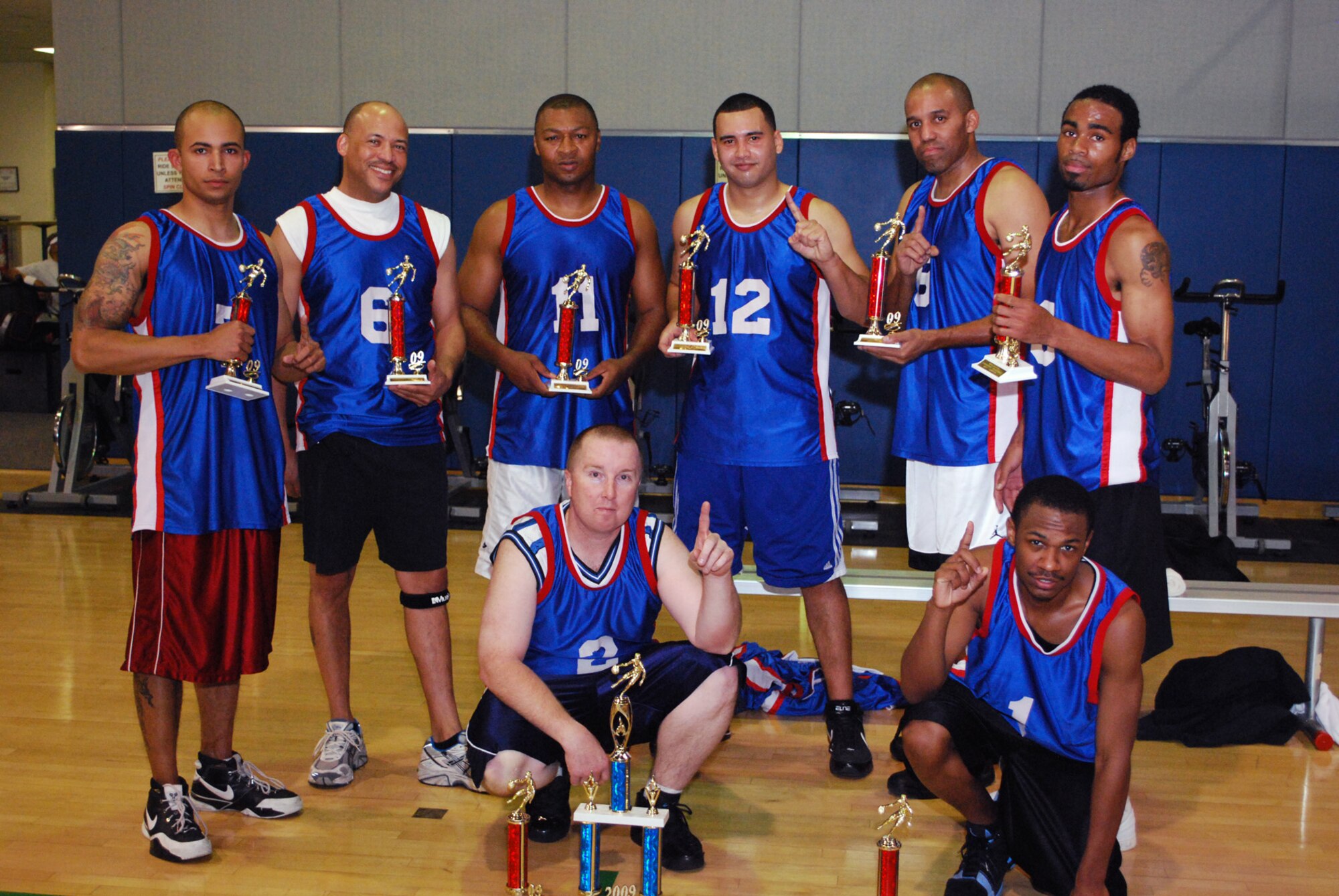 THE CHAMPS: The Navy team displays their championship trophies after the presentation in the Fitness Center, Jan. 7. The beat 452 SFS #1 in the championship game, 57 to 46. (U.S. Air Force photo)