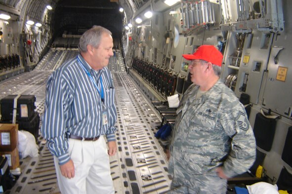 Roger Rupp, Boeing liaison to March ARB, speaks with Senior Master Sgt. Bruce Becker inside the C-17 that joined the 452 AMW fleet on Tuesday. SMSgt. Becker assisted with the preacceptance inspection in Charleston, S.C. (U.S Air Force photo by Will Alexander)