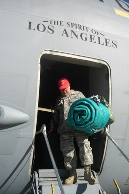 Senior Master Sgt. Bruce Becker, who helped with the C-17’s preacceptance inspection in Charleston, gets off the aircraft. (U.S Air Force photo by Will Alexander)