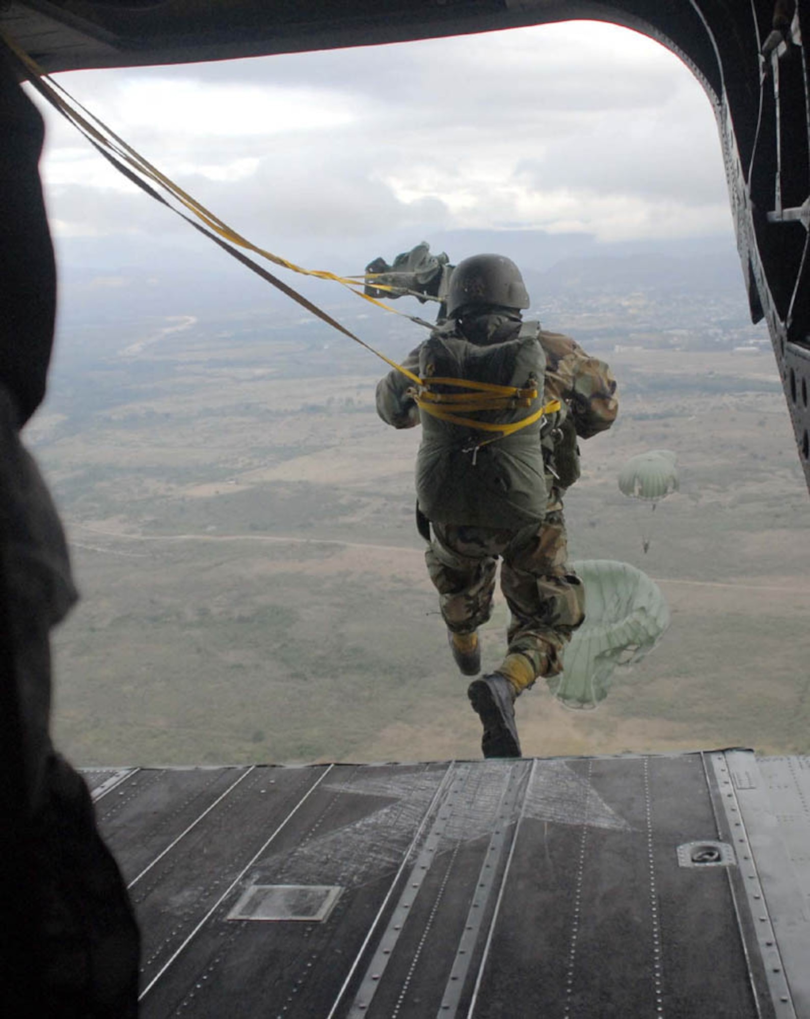 SOTO CANO AIR BASE, Honduras - A Honduran soldier steps out the back of a U.S. Army CH-47D Chinook helicopter during combined airborne operations training here Jan. 15.   U.S. and Honduran soldiers train together to learn from each other and to build cohesion between the units.  (US Air Force photo/Tech Sgt. Rebecca Danét)