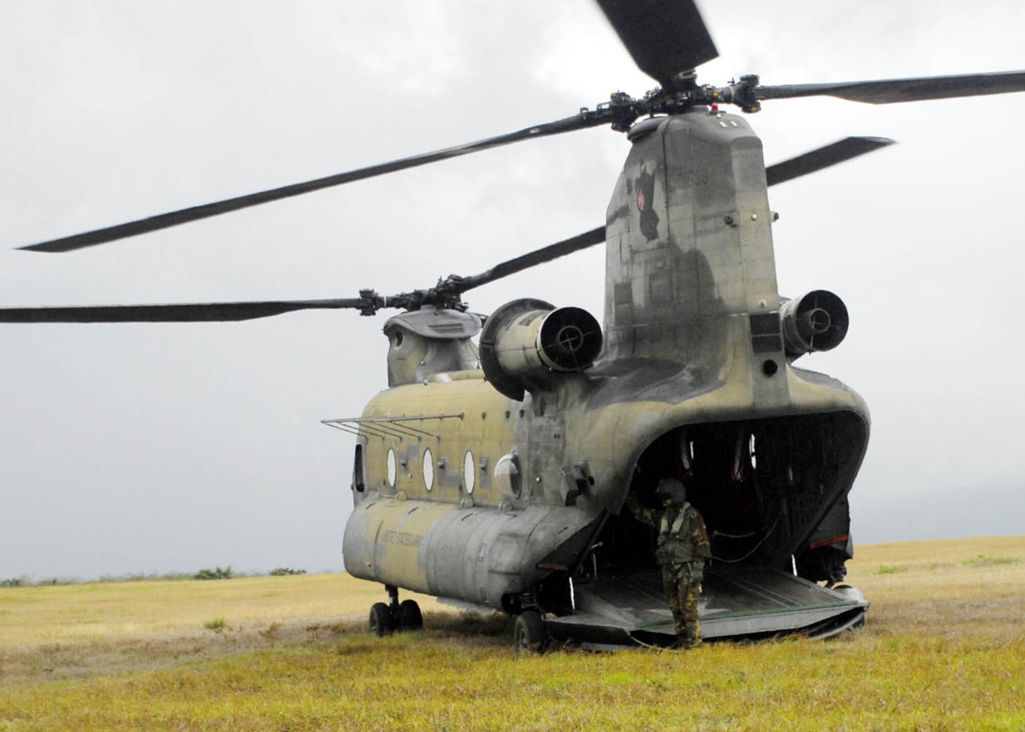 SOTO CANO AIR BASE, Honduras - A flight engineer from Bravo Company, 1st Battalion, 228th Aviation Regiment, waits for U.S. paratroopers to re-board a CH-47D Chinook helicopter here during combined airborne operations training Jan. 15.  The U.S. and Honduran Armies train together to learn from each other and to build cohesion between the units.  (US Air Force photo/Tech. Sgt. Rebecca Danét)