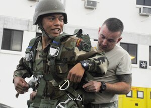 SOTO CANO AIR BASE, Honduras - U.S. Army Forces 1st Sgt. Lloyd Broom conducts a jump master performance inspection for Honduran Army Sgt. Alex Armando Paris during combined airborne operations training here Jan. 15.  The two services train together to learn from each other and to build cohesion between the units.  (US Air Force photo/Tech. Sgt. Rebecca Danét)   