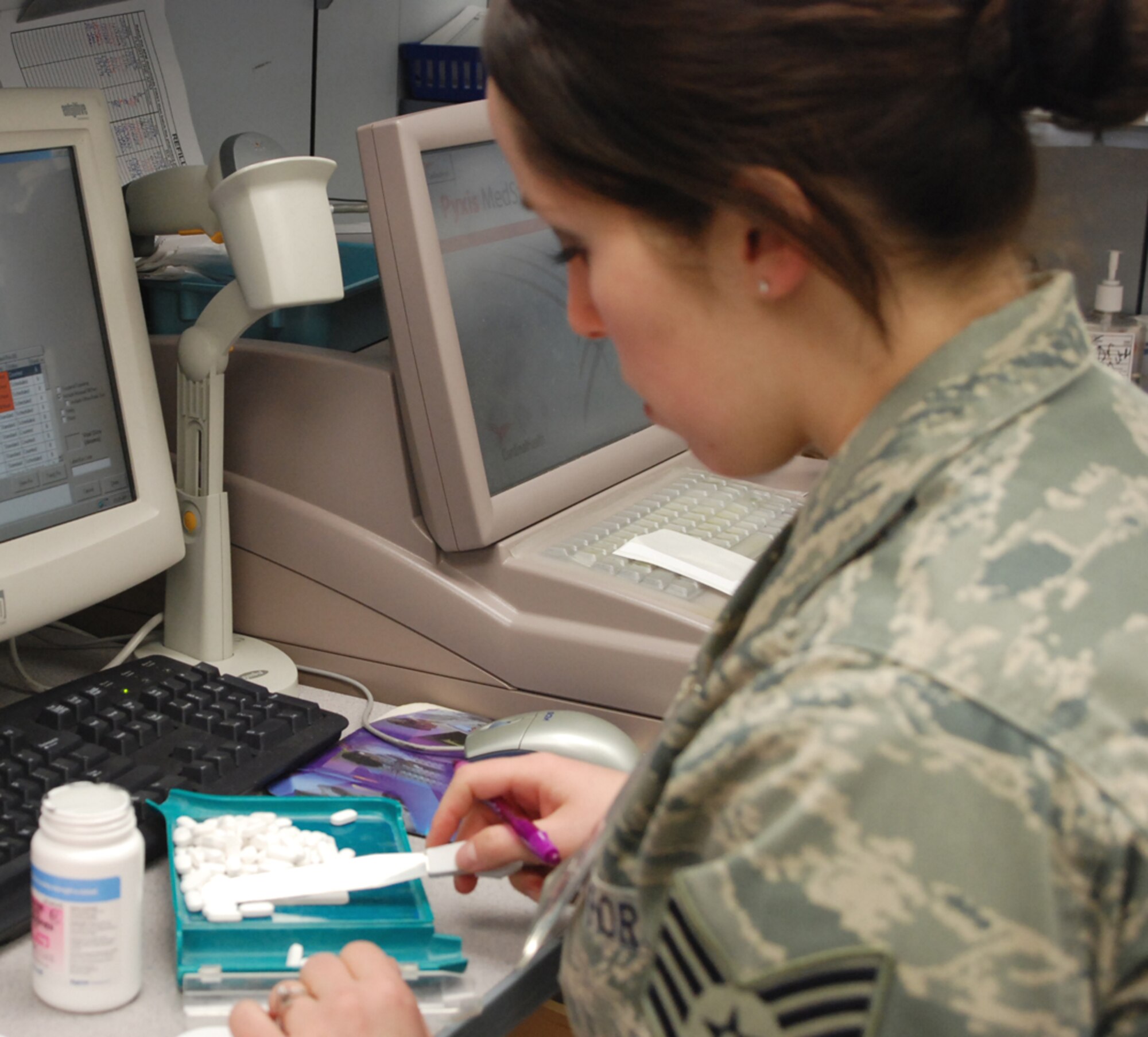 Staff Sgt. Tiffany Romano, the 9th Medical Support Squadron NCO in-charge of the outpatient pharmacy, counts pills to fill a prescription Jan. 21 at the base pharmacy. The pharmacy pays close attention to detail in order to assure 100 percent safety to the beneficiaries they serve. (Photo by Airman 1st Class Chuck Broadway)