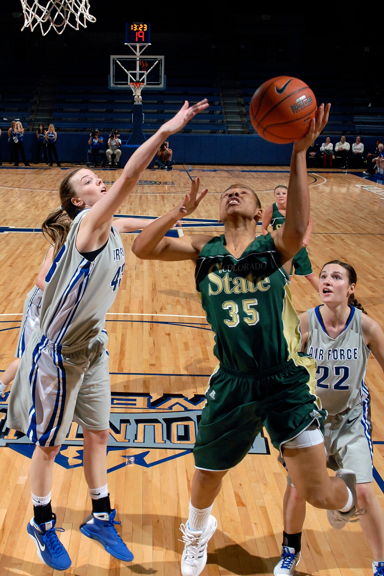 Senior center Kim Kreke attempts to block a shot by Colorado State University's Juanise Cornell during the Falcons 55-50 loss to the Colorado State Rams Jan 20 at Clune Arena at U.S. Air Force Academy, Colo. Kreke notched her sixth double-double of the season with 10 points and 14 rebounds The Falcons dropped to 0-5 in Mountain West Conference action and 4-14 overall.  (U.S. Air Force photo/Mike Kaplan)
