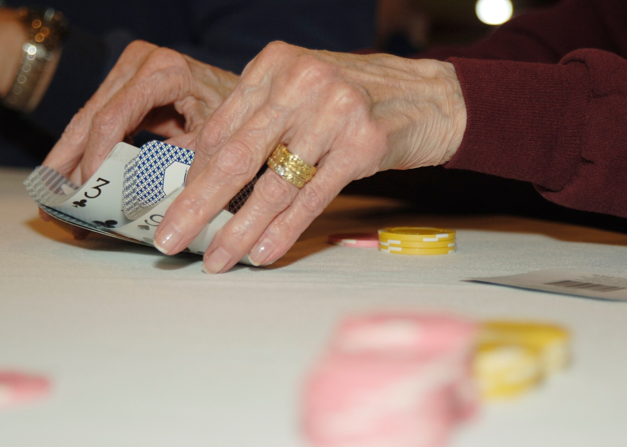 MCCONNELL AIR FORCE BASE, Kan. -- Mary Wilson shuffles a deck of cards during a poker tournament held at Signatures lounge, Jan. 17. The prize for the night’s winner was $15 service bucks, which can be used around base.  (Photo by Airman 1st Class Maria Ruiz)