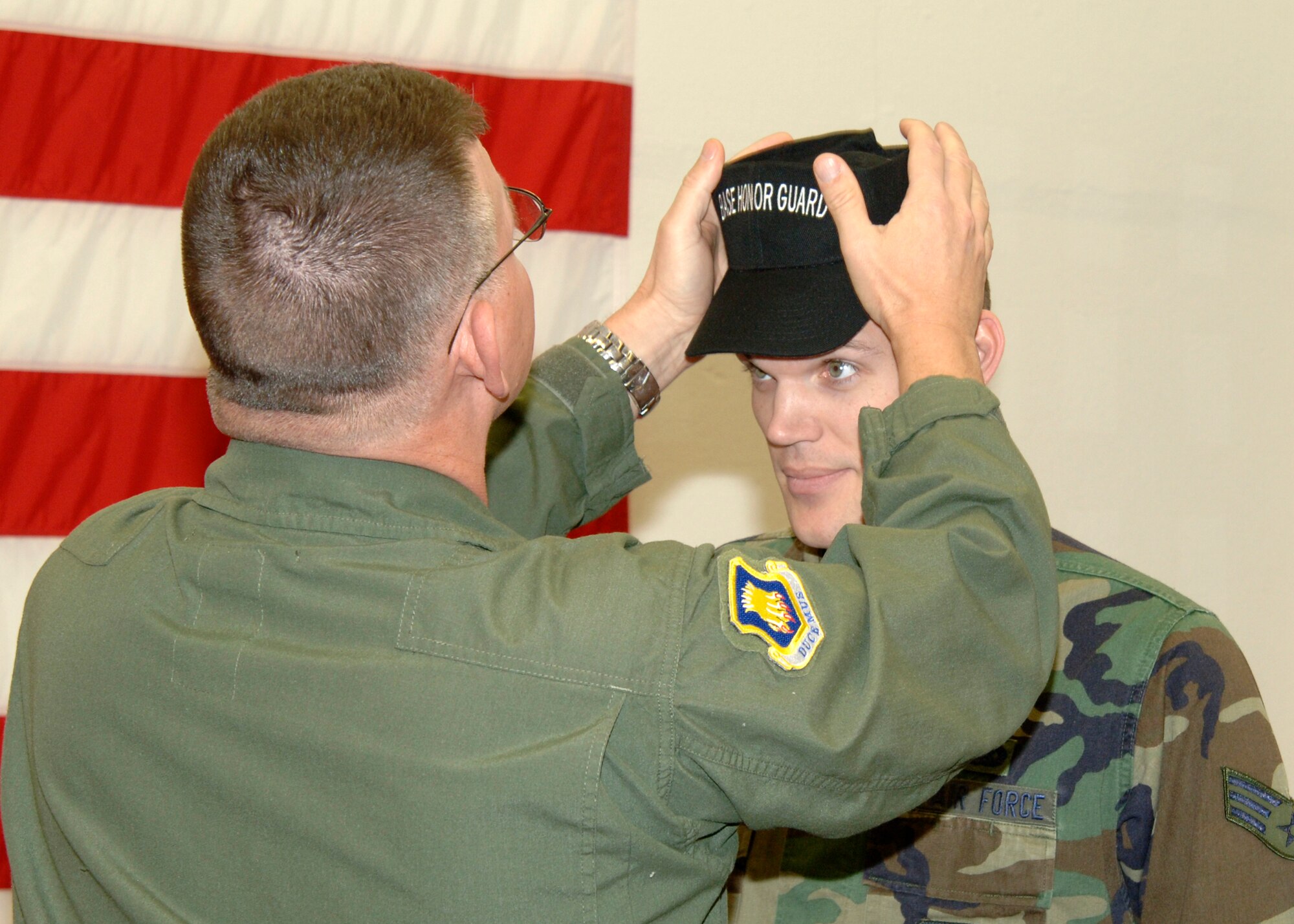 MCCONNELL AIR FORCE BASE, Kan. -- Chief Master Sgt. Jim Morman, 22nd Air Refueling Wing interim command chief, presents Senior Airman David Neff, 22nd Maintenance Squadron, with his black hat during a ceremony held in the honor guard building, Jan. 21. Senior Airmen Keith Wines, 22nd Maintenance Squadron, and Vincente Gonzalez Jr., 22nd Operations Support Squadron, were also awarded black hats during the ceremony. (Photo by Senior Airman Laura Suttles)