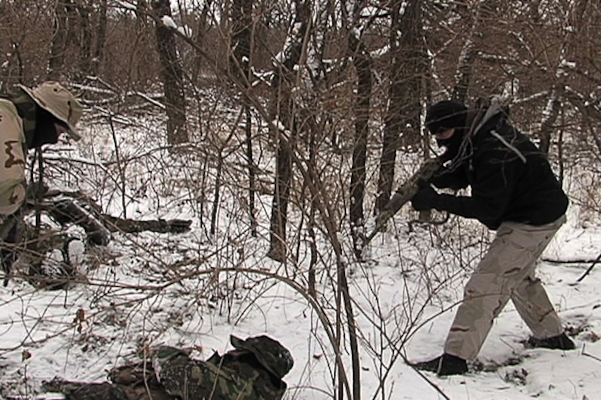 MCCONNELL AIR FORCE BASE, Kan. -- Staff Sgt. Jeremy Bissell, 184th Security Forces Squadron, left, and Tech. Sgt. Justin Christman, 184th Security Forces Squadron, right, secure Senior Airman Matthew Sutherland, 184th Security Forces Squadron during a survival, evasion, resistance, and escape refresher course, Jan. 15.  This training will keep the students current for another three years. (Photo by Master Sgt. Christopher Wuerthner)