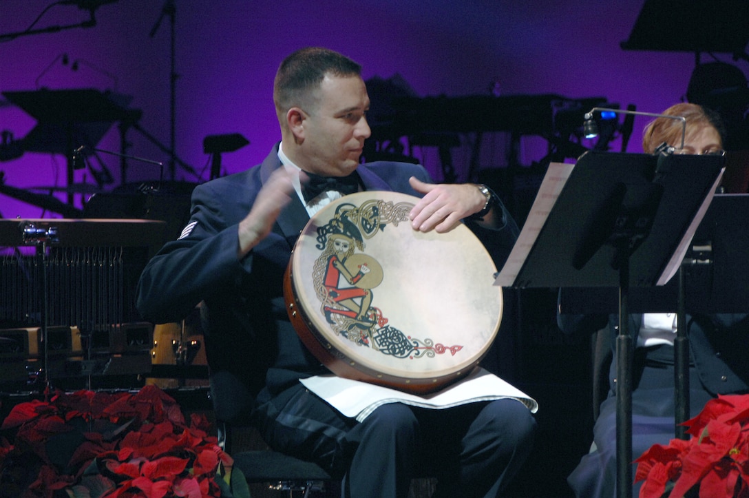 Staff Sergeant Gary Steinberg plays a drum during Winds of Freedom's rendition of 'Patapan' during the USAF Heartland of America Band's 2008 Holiday Show 'The Promise of the Season.'