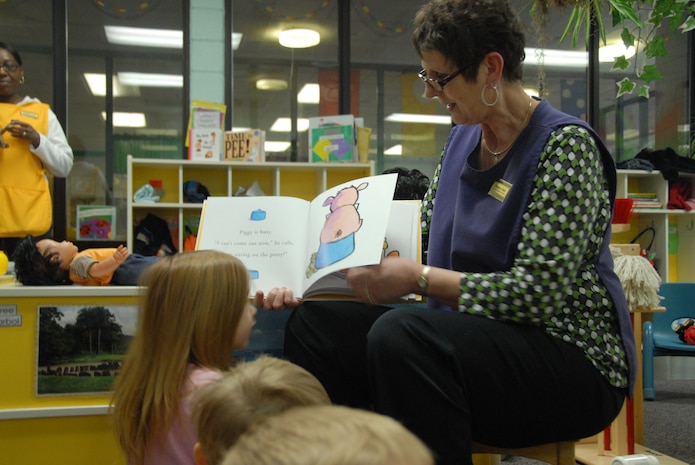 Christine Owen reads a book to children at the Brig. Gen. Thomas R. Mikolajcik Child Development Center here Jan. 20.  The CDC recently earned national accreditation through the National Association for the Education of Young Children. Ms. Owen is a supervisory education technician at the CDC. (U.S. Air Force photo/Staff Sgt. Jennifer Arredondo)