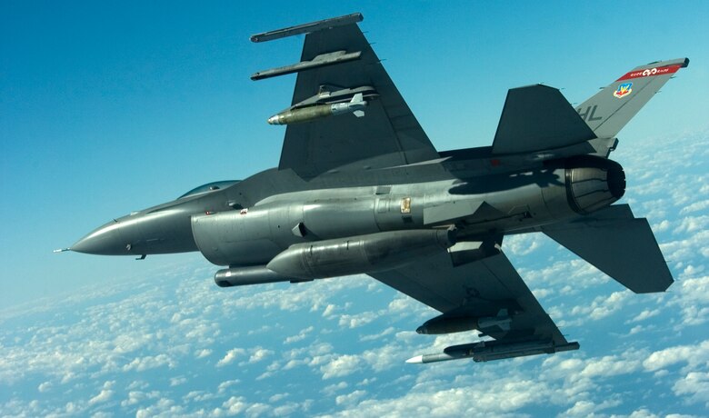 A F-16 Fighting Falcon from the 34th Fighter Squadron at Hill Air Force Base, Utah, banks right displaying ordnance to be released during a Weapons System Evaluation Program mission, Jan 14.  The 34 FS participated in the first-ever combined WSEP Jan. 12-15.  This WSEP combined the live air-to-air missile firing of Combat Archer and the air-to-ground bomb drops of Combat Hammer into one continuous mission.  This major undertaking brought together the WSEP evaluators from the 83rd Fighter Weapons Squadron, located at Tyndall Air Force Base, Fla., and the 86th Fighter Weapons Squadron at Eglin.  This new combined mission began with the aircraft load and launch from Tyndall.  Then the pilot performed a live missile firing over the Gulf of Mexico.  After the missile launch, the pilot connected with a KC-135 Stratotanker from MacDill Air Force Base, Fla., for refueling.  Then, the pilot flew over the Eglin range to perform a live bomb drop.  (U.S. Air Force photo\Tech Sgt. Jason Wilkerson.)