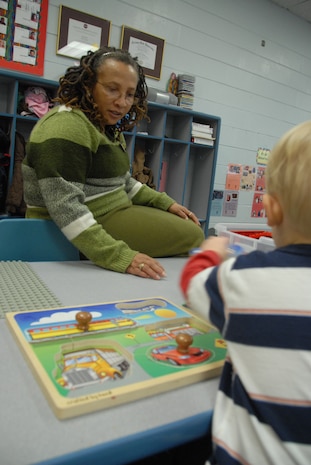 Belinda Evans works on a puzzle with a student in the toddler  room at the Brig. Gen. Thomas R. Mikolajcik Child Development Center here Jan. 20.  The CDC recently earned national accreditation through the National Association for the Education of Young Children. Ms. Evans is the training and curriculum specialist at the center. (U.S. Air Force photo/Staff Sgt. Jennifer Arredondo)