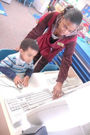 Tess Mitchell helps Pierce Leverett access the Internet at the Brig. Gen. Thomas R. Mikolajcik Child Development Center here Jan. 20.  The CDC recently earned national accreditation through the National Association for the Education of Young Children. Ms. Mitchell is a program assistant with the center and Pierce is the son of Staff Sgt. Nicole Futrell who is  currently stationed at Ramstein AB, Germany. (U.S. Air Force photo/Staff Sgt. Jennifer Arredondo)
