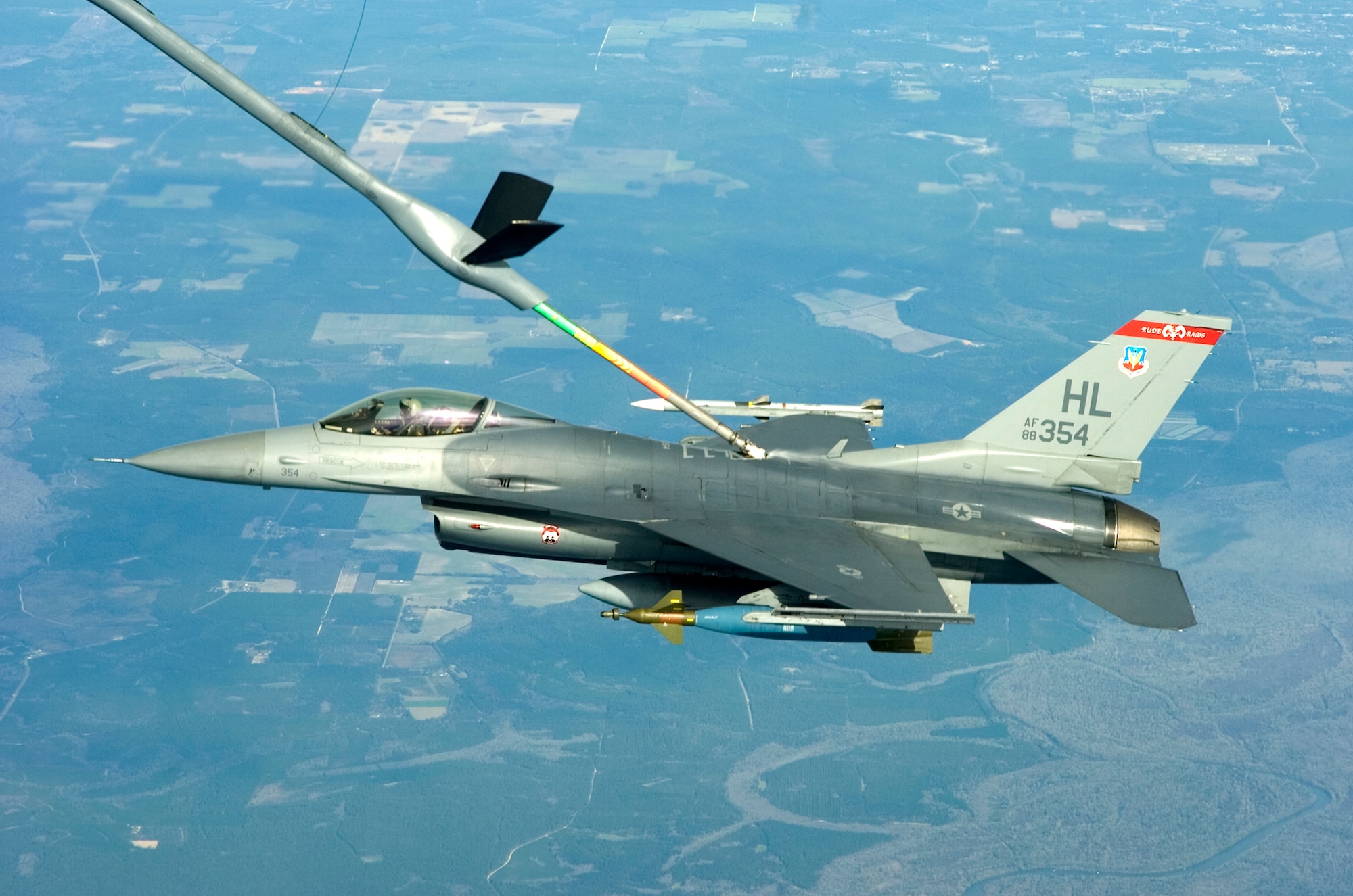 A F-16 Fighting Falcon from the 34th Fighter Squadron at Hill Air Force Base, Utah, connects with a KC-135 Stratotanker from MacDill Air Force Base, Fla., for a quick gas-n-go during a Weapons System Evaluation Program mission, Jan 14.  The 34 FS participated in the first-ever combined WSEP Jan. 12-15.  This WSEP combined the live air-to-air missile firing of Combat Archer and the air-to-ground bomb drops of Combat Hammer into one continuous mission.  This major undertaking brought together the WSEP evaluators from the 83rd Fighter Weapons Squadron, located at Tyndall Air Force Base, Fla., and the 86th Fighter Weapons Squadron at Eglin.  This new combined mission began with the aircraft load and launch from Tyndall.  Then the pilot performed a live missile firing over the Gulf of Mexico.  After the missile launch, the pilot connected with a KC-135 Stratotanker from MacDill Air Force Base, Fla., for refueling.  Then, the pilot flew over the Eglin range to perform a live bomb drop.  (U.S. Air Force photo\Tech Sgt. Jason Wilkerson.)
