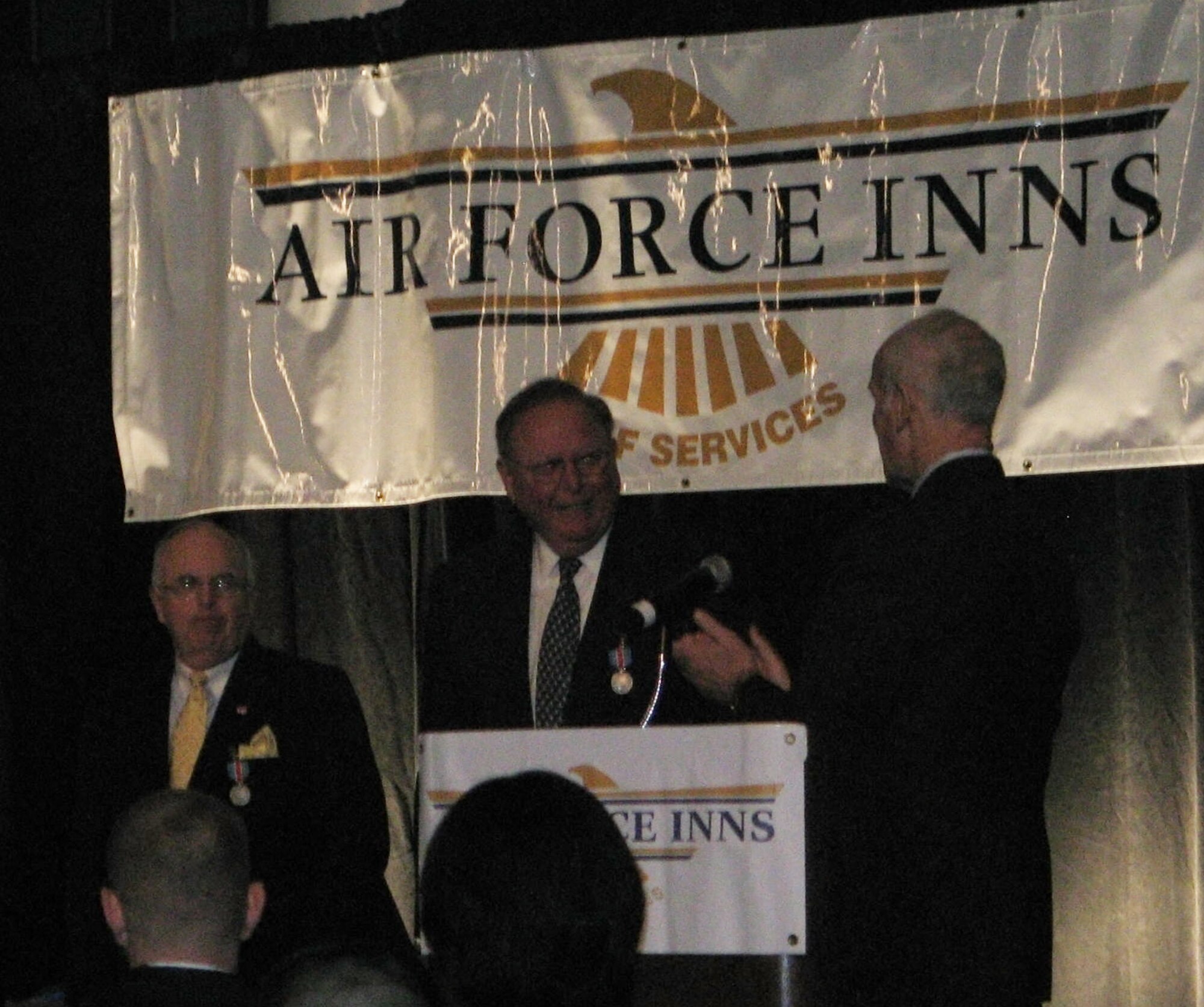 Art Myers, Air Force Services director, speaks after presenting the Commander's Award for Public Serivce to Joseph McInerney and Joseph Spinnato during the annual Air Force Innkeeper Awards, November 2008, at the International Hotel/Motel Restaurant Show, New York City, NY. Mr. McInerney is president and chief executive officer of the American Hotel & Lodging Association and Mr. Spinnato is president and CEO of the Hotel Association of New York City, Inc. (Photo courtesy of Military Club & Hospitality)