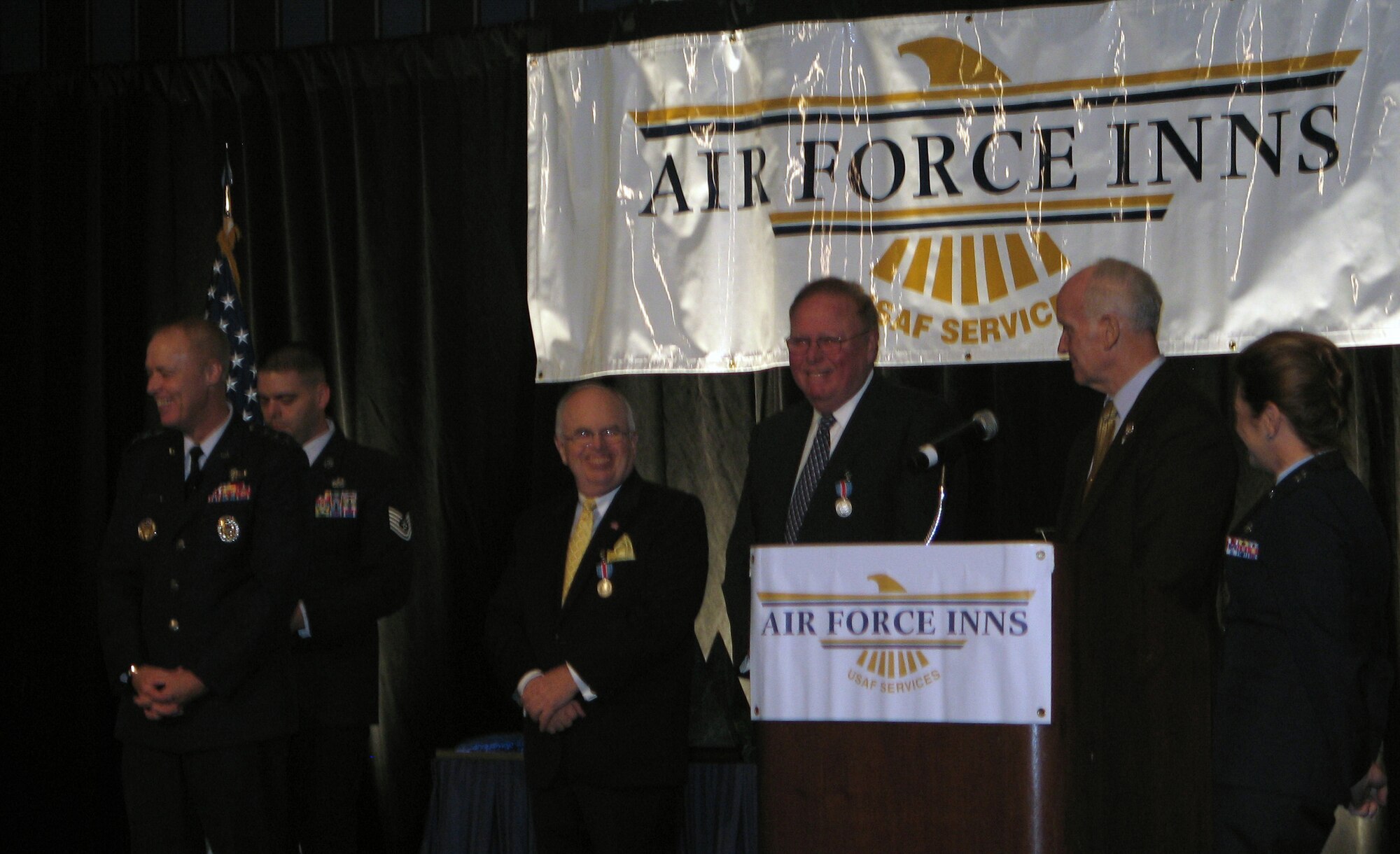 Mr. Joseph McInerney and Mr. Joseph Spinnato smile after being presented the Commander's Award for Public Service at the annual Air Force Innkeeper Awards, November 2008, at the International Hotel/Motel Restaurant Show, New York City, NY. Lt. Gen. Richard Newton, Deputy Chief of Staff for Manpower and Personnel, Headquarters U.S. Air Force, Washington, D.C., and Art Myers, Air Force Services director, presented the award. Mr. McInerney is president and chief executive officer of the American Hotel & Lodging Association and Mr. Spinnato is president and CEO of the Hotel Association of New York City, Inc. (Photo courtesy of Military Club & Hospitality)