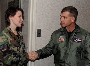 LANGLEY AIR FORCE BASE, Va. -- Staff Sgt. Danielle Diaz, 1st Surgical Operation Squadron, aerospace medical technician, receives a coin from Brig. Gen. Mark A. Barrett, 1st Fighter Wing, commander Jan. 14.  Sgt. Diaz helped reestablish the bereavement program to help families cope with the loss of a child.  (U.S. Air Force photo/Airman 1st Class Zachary Wolf)