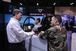 Two Airmen try their hand at flying in a F-35 Lightning II simulator at the Air Education and Training Command simulator Jan. 15. The command hosted the symposium to showcase new innovations and technology that Airmen can soon expect to see coming their way. (U.S. Air Force photo by Rich McFadden)