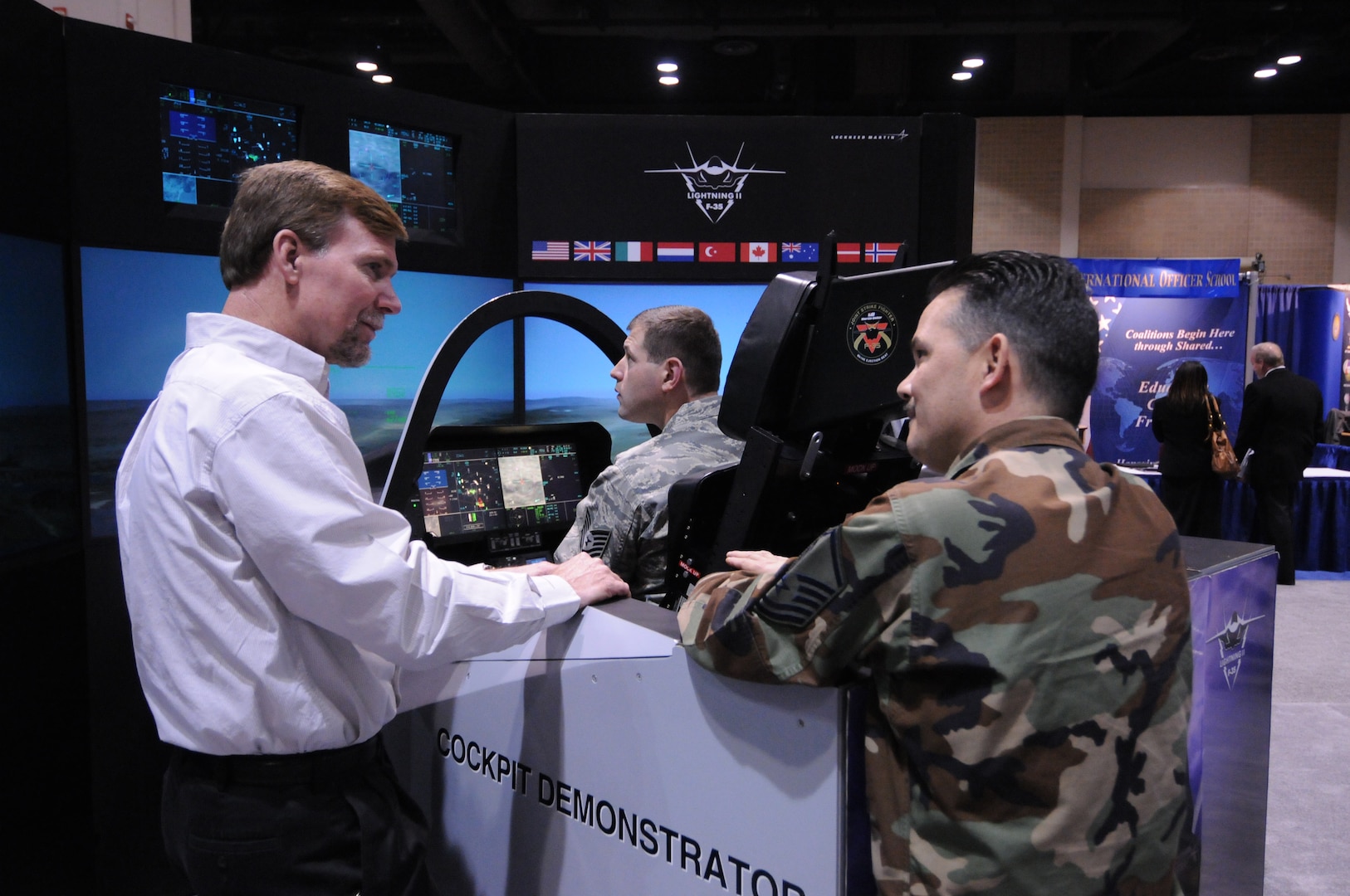 Two Airmen try their hand at flying in a F-35 Lightning II simulator at the Air Education and Training Command simulator Jan. 15. The command hosted the symposium to showcase new innovations and technology that Airmen can soon expect to see coming their way. (U.S. Air Force photo by Rich McFadden)