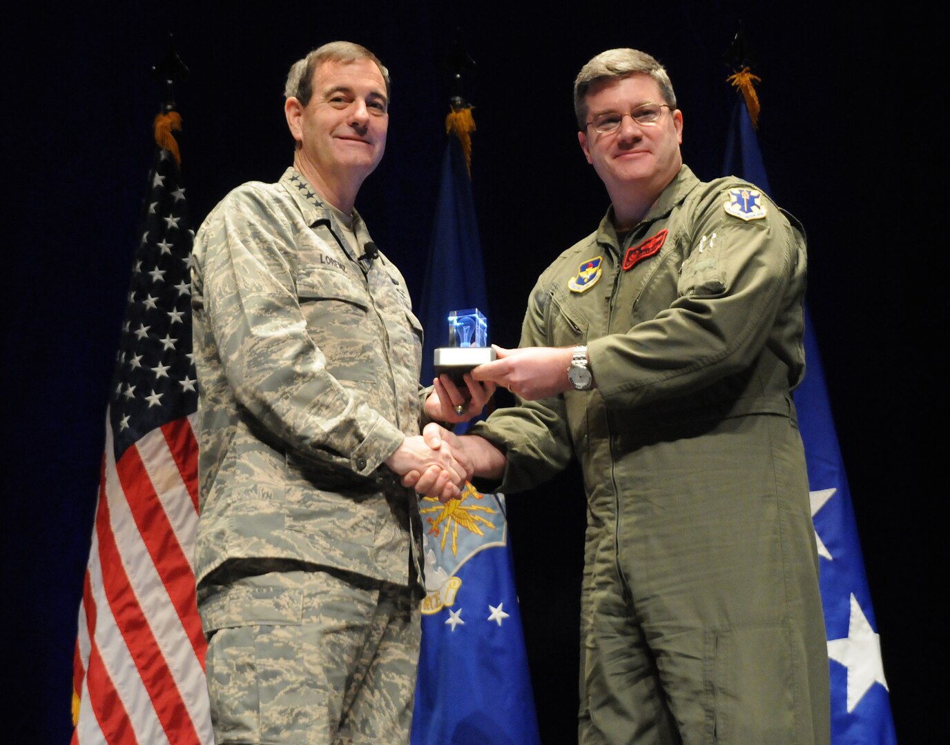 Gen. Stephen Lorenz, Air Education and Training Command commander, presents the AETC Learning Innovation Award for Training to Lt. Col. Chris Wellborn, 563rd Flying Training Squadron. Several 563rd programs earned the squadron accolades from the major command-level. (U.S. Air Force photo by Rich McFadden)