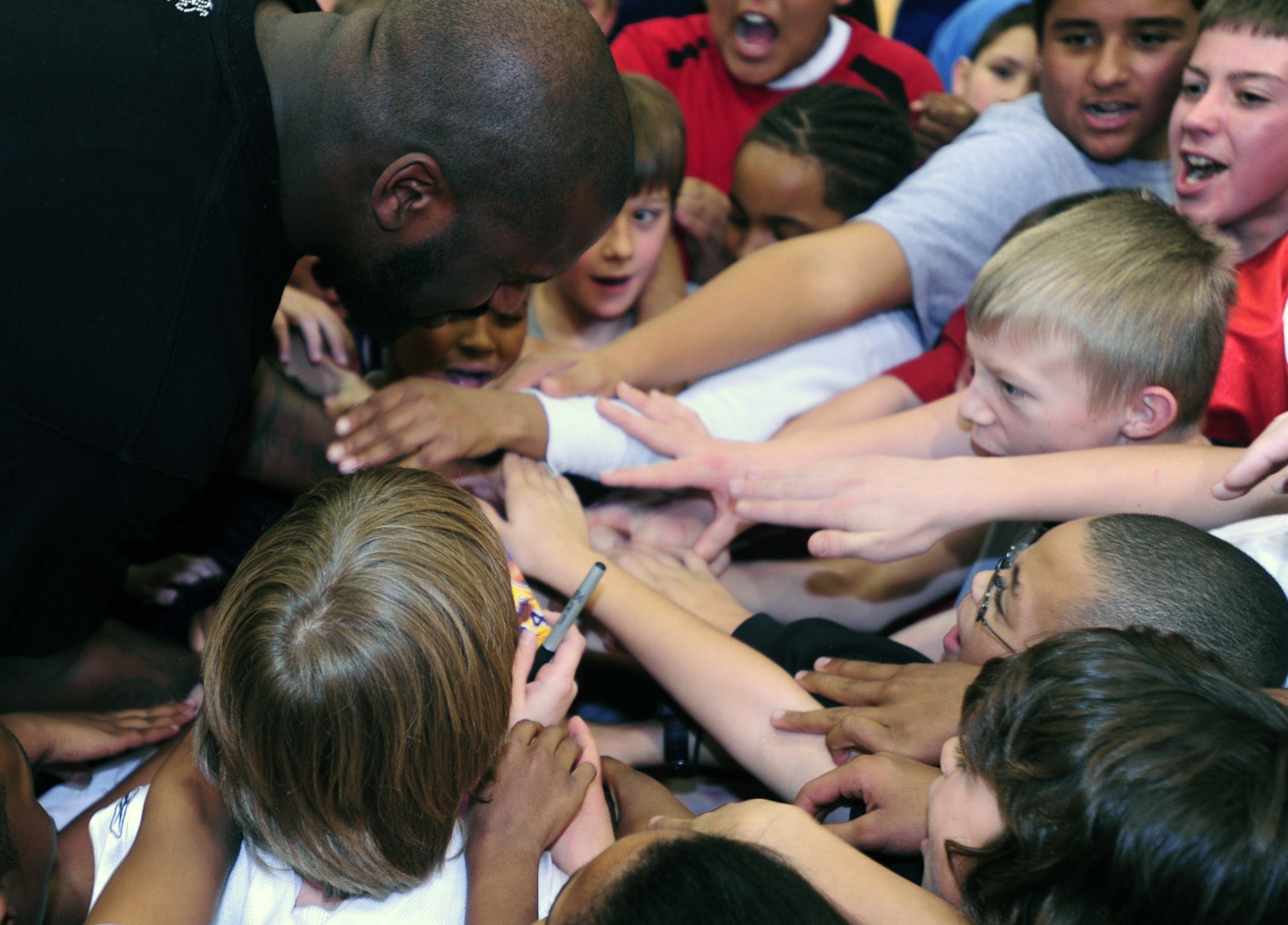 Shaquille O'Neal of the Phoenix Suns gets children pumped up with a "One, two, three, Buckley" chant during a basketball clinic Jan. 14 at Buckley Air Force Base, Colo. (U.S. Air Force photo/Airman 1st Class Alex Gouchnour) 
