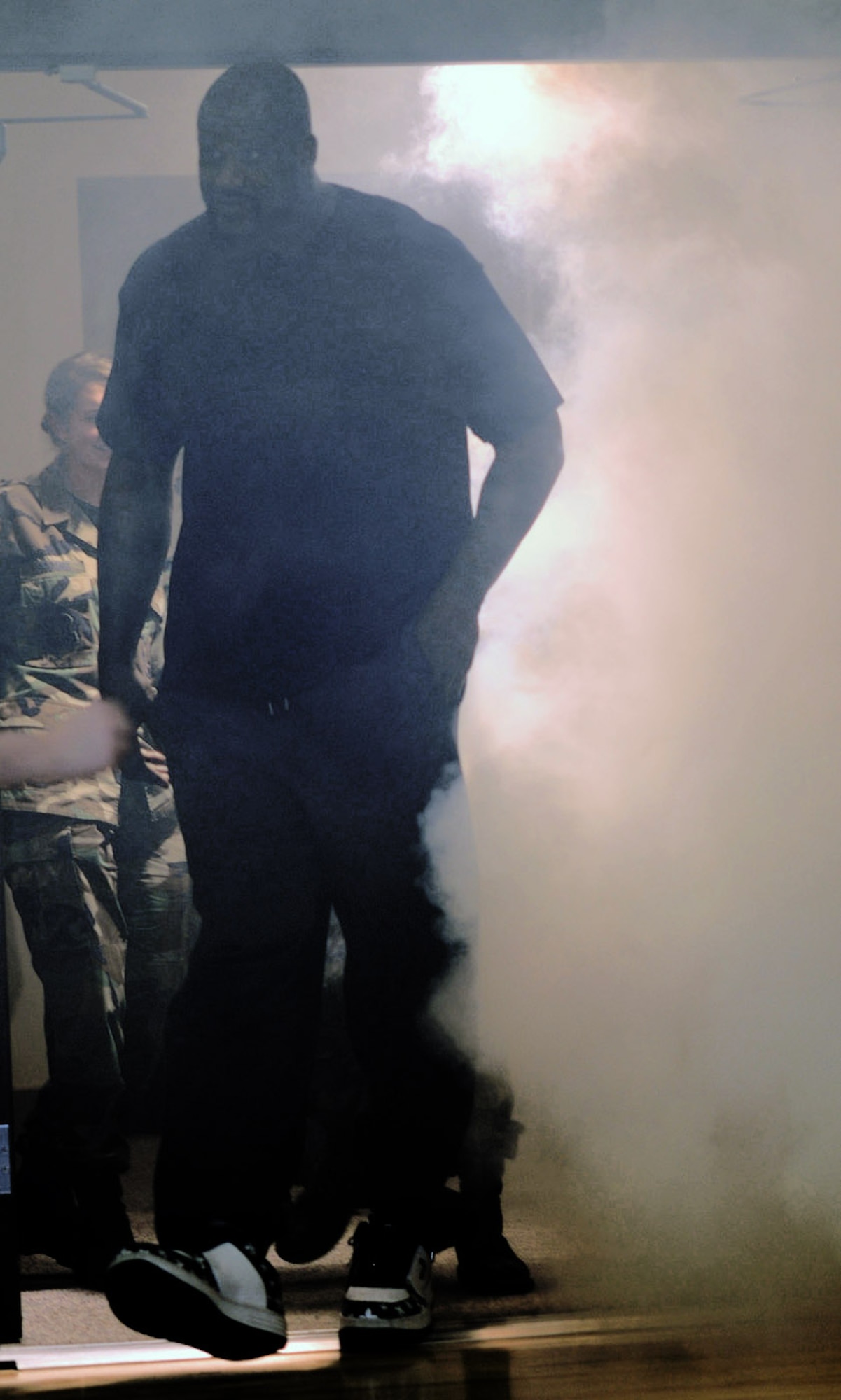 Shaquille O'Neal of the Phoenix Suns makes his entrance through clouds of smoke to meet more than 265 children of military members during a basketball clinic Jan. 14 at the fitness center on Buckley Air Force Base, Colo. (U.S. Air Force photo/Airman 1st Class Alex Gouchnour) 
