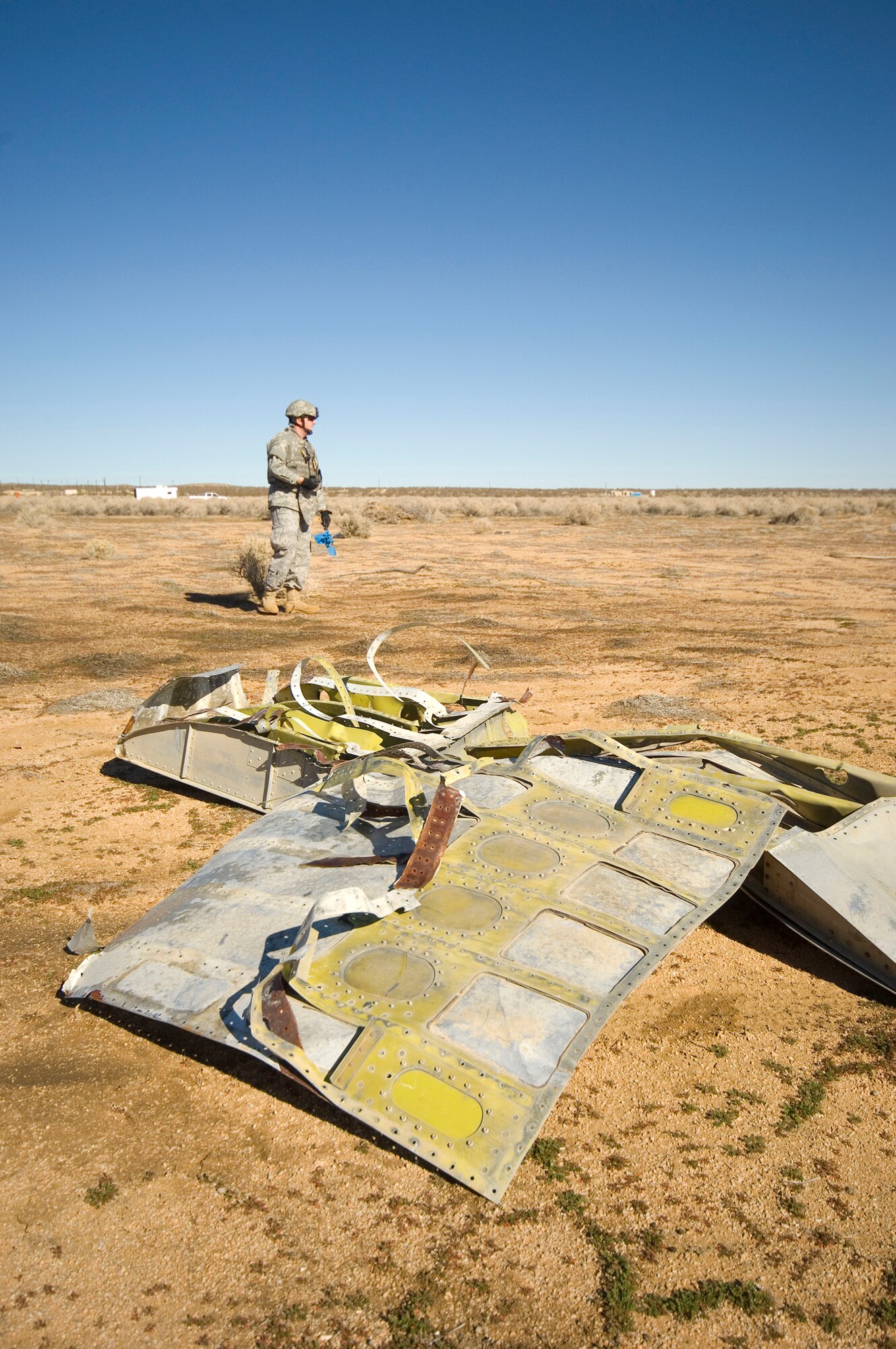 An Edwards Explosive Ordnance Disposal Unit Airman assesses a simulated F-16 Fighting Falcon crash site at Camp Corum Jan. 12 as part of the base's Unit Compliance Inspection. The base received an overall UCI score of "Excellent" and a Logistics Standardization Evaluation Team inspection grade of "Satisfactory." (Air Force photo by Mike Cassidy)