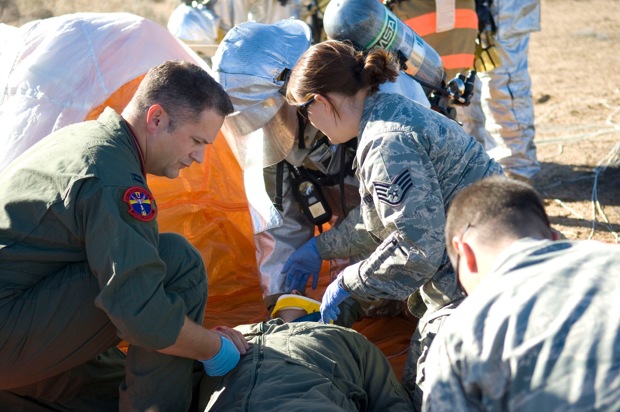 Edwards first responders provide medical treatment to a survivor of a simulated F-16 Fighting Falcon crash at Camp Corum here Jan. 12. This is part of a Unit Compliance Inspection conducted on base Jan. 9 through 16 where the Air Force Materiel Command Inspector General team inspected the base's common core compliance areas. These areas represent key processes, procedures and requirements based on by-law requirements, executive orders, Department of Defense directives and Air Force and AFMC instructions. (Air Force photo by Mike Cassidy)