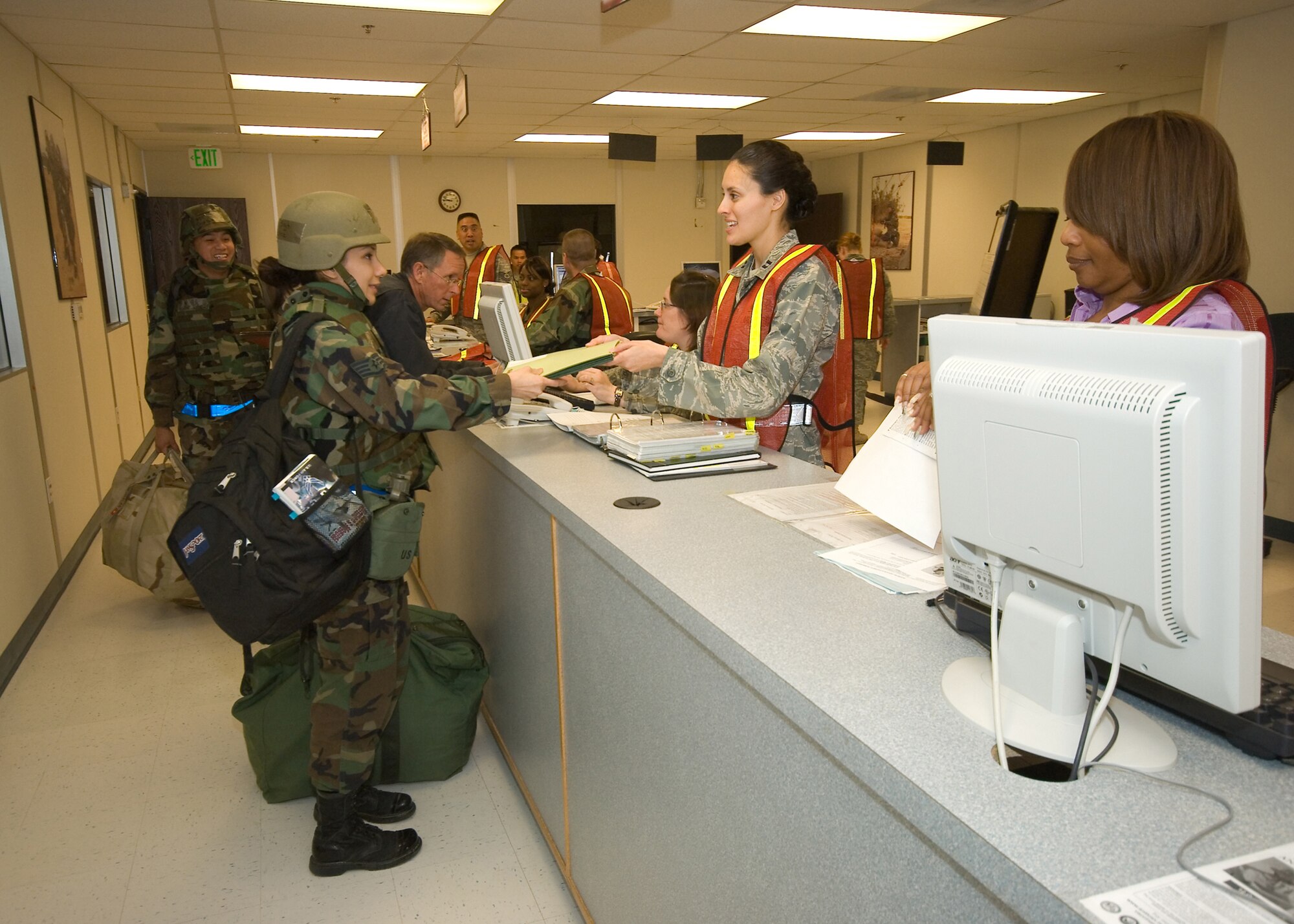 Edwards Airmen go through the processing line during a Targeted Readiness Inspection at the Mobility Processing Center Jan. 9 as part of the base's Unit Compliance Inspection. The TRI assessed the base's initial response portion of readiness with special focus on mobility processing, hazardous cargo processing, weapons handling, deployment records, mobility bags, and cargo handling. The TRI is based on previous findings, such as the past Operational Readiness Inspection, and Air Force and AFMC systemic trends. (Air Force photo by Michael Yncera)