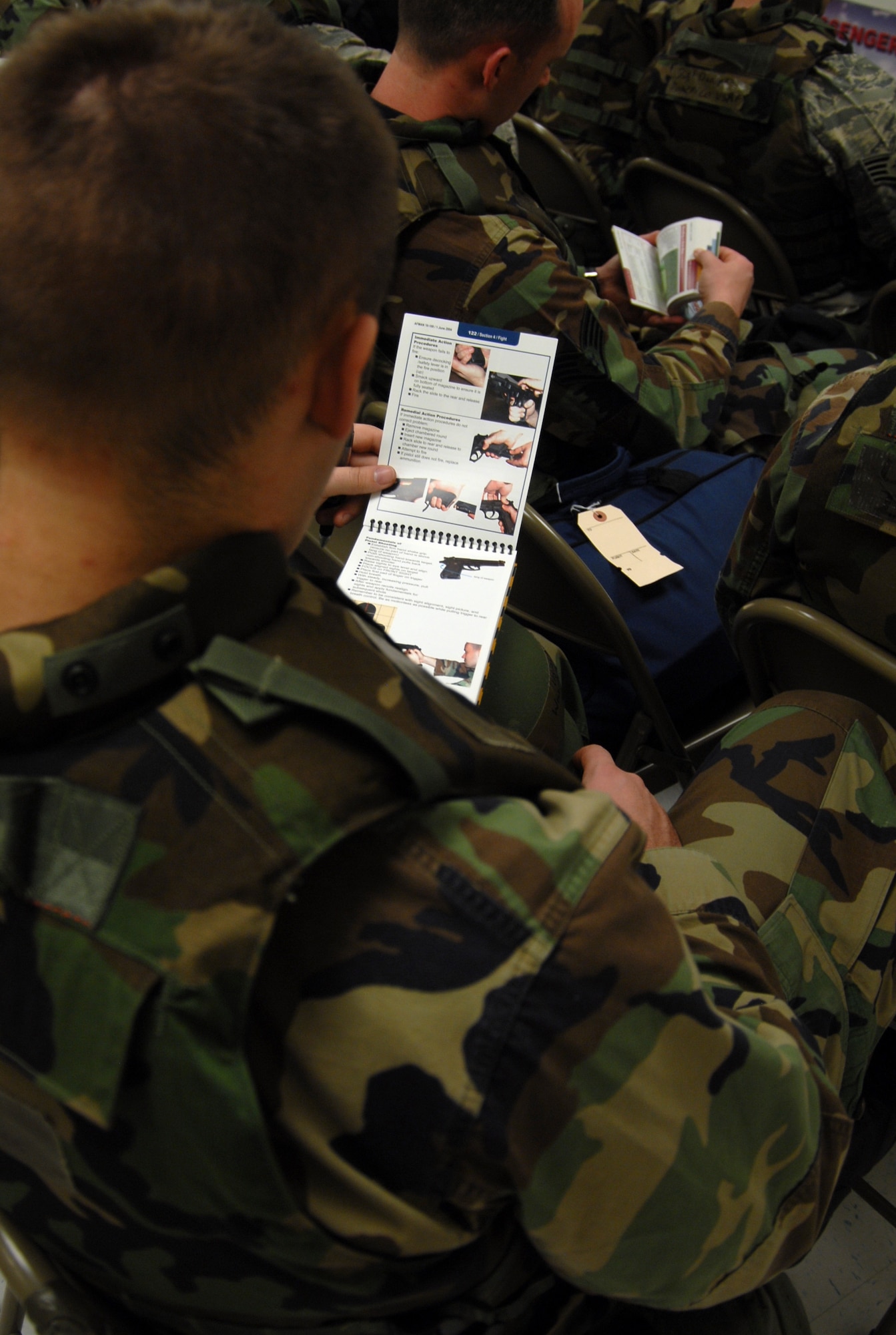 An Edwards Airman reviews his Air Force Manual 10-100 during the base's Targeted Readiness Inspection Jan. 9 at the Mobility Processing Center. The base received an "Excellent" mark during the inspection. (Air Force photo by Senior Airman Julius Delos Reyes)