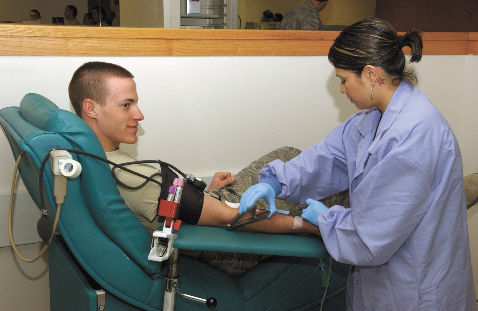 1/13/2009 - Lorraine Castillo, a phlebotomist, takes the blood of Air Force basic military trainee Kyle Conger, 320th Training Squadron, at the Lackland Blood Donor Center Jan. 13. January is National Blood Donor Month. The Lackland Blood Donor Center thanks everyone who has given blood and encourages those who have not to consider becoming regular donors. (USAF photo by Alan Boedeker)                        