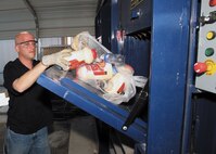 1/9/2009 - Daniel Lange of the Lackland Recycling Center processes plastics in one of the center's new balers. The Lackland recycling program has earned 10 awards from the state and has been judged the best by Cooperative Teamwork & Recycling Assistance. (USAF photo by Robbin Cresswell)