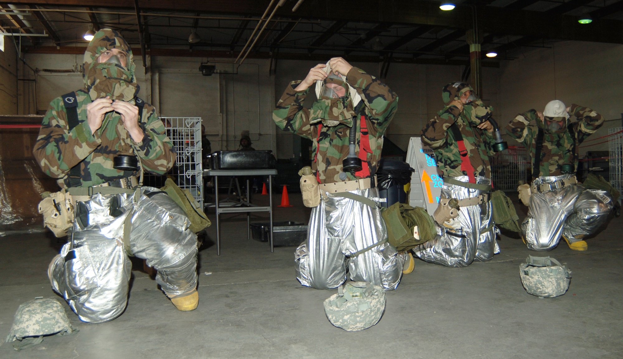 MCCONNELL AIR FORCE BASE, Kan. -- McConnell firefighters suit up into Mission Oriented Protective Posture level four in less than two minutes during drills, Jan. 16. Zone transitioning and safe canteen drinking procedures were also put into practice. (Photo by Airman 1st Class Maria Ruiz)