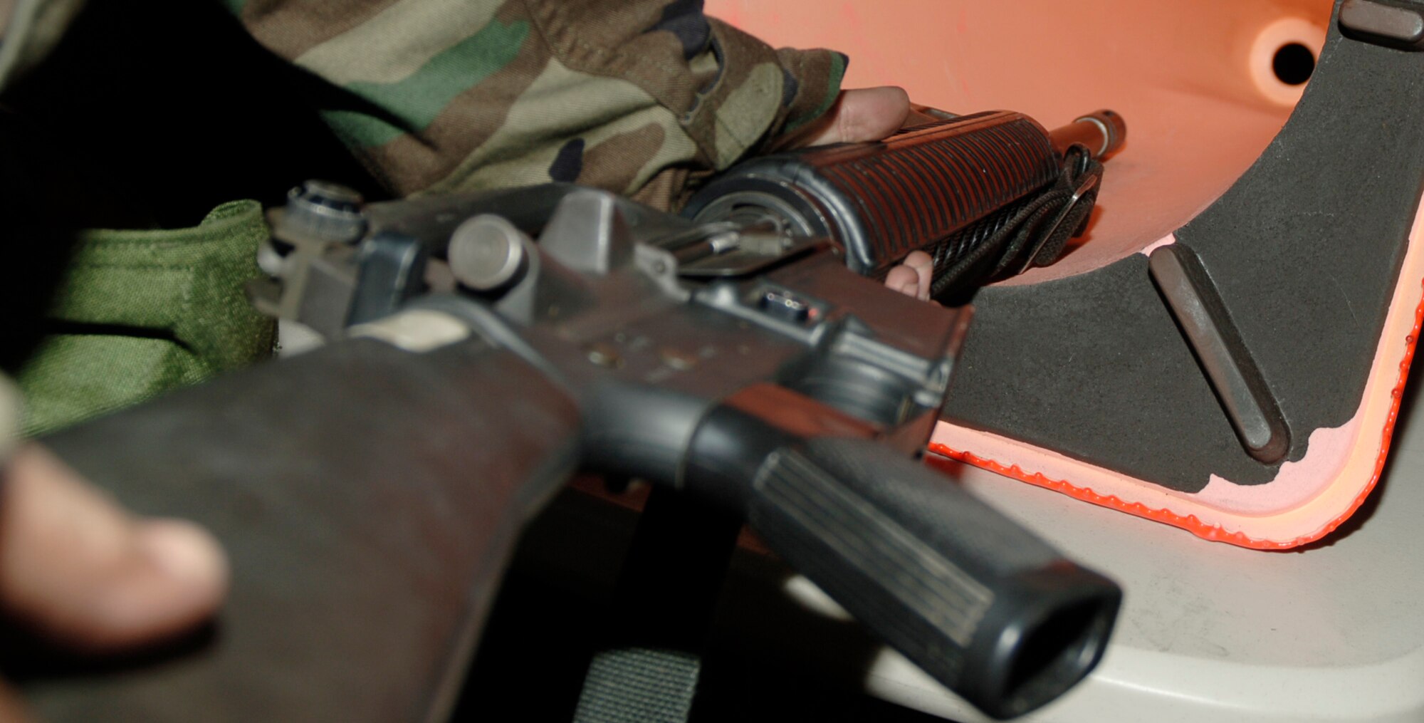 MCCONNELL AIR FORCE BASE, Kan. -- Participants in the Ability to Survive and Operate rodeo polish up on clearing procedures for M-16 rifles and M-9 pistols at the weapons familiarization area, Jan. 16. Other topics reviewed were loading procedures and proper issuing of weapons.  (Photo by Airman 1st Class Maria Ruiz)