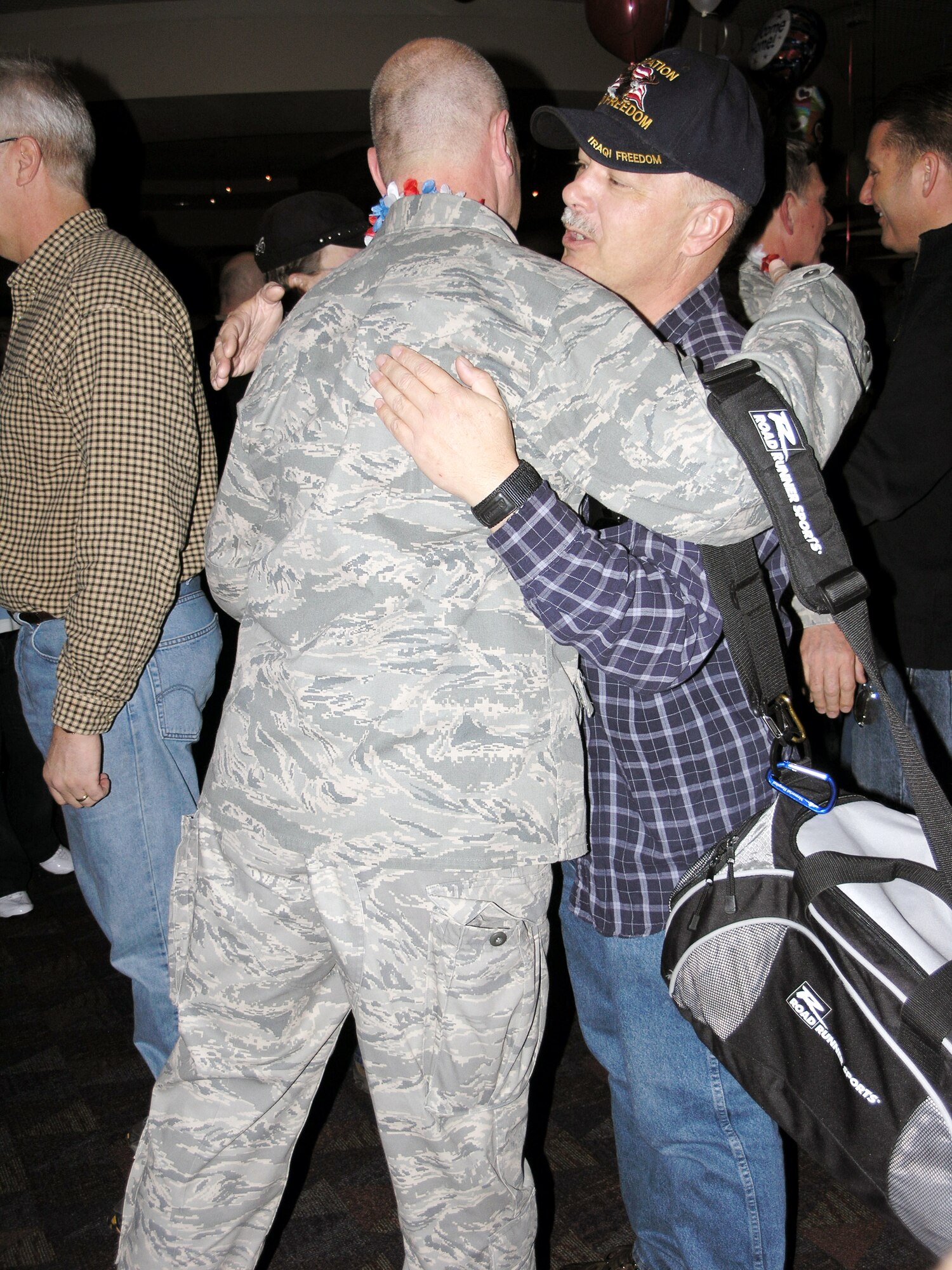 Senior Master Sgt. David King welcomes home Maj. William Horvath from a four-month long tour at Balad Air Base, Iraq.  (U.S. Air Force photo/Tech. Sgt. David D. Morton)