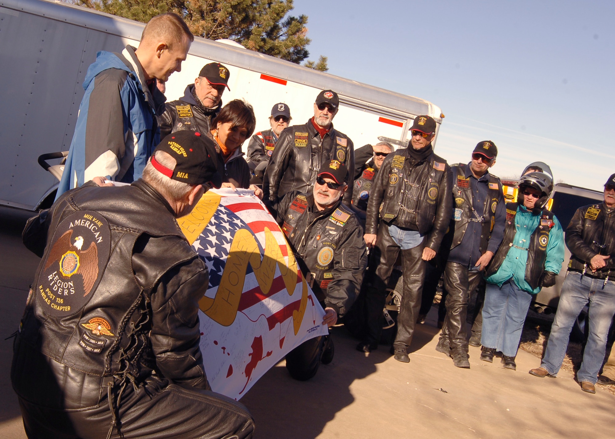 ROSE HILL, Kan. -- The American Legion Riders, Kansas chapter, present a welcome home flag to Purple Heart recipient Master Sgt. David Webber, 22nd Medical Operations Squadron, and his wife, Tech. Sgt. Debbie Webber, 22nd Logistics Readiness Squadron, at their home, Jan. 17. Along with the flag, Sergeant Webber received a coin and Purple Heart certificate, as well as a another coin from the Veterans of Foreign Wars Riders, Derby chapter. (Photo by Airman 1st Class Maria Ruiz)