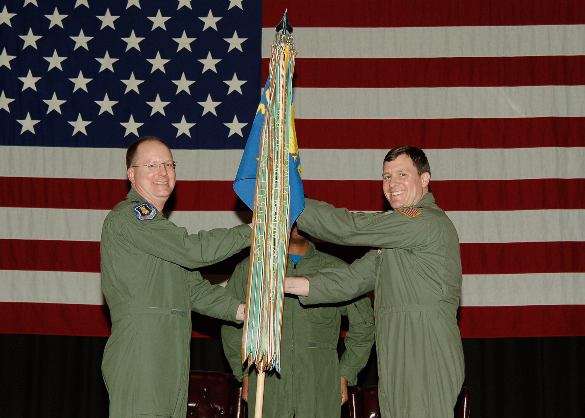 MCCONNELL AIR FORCE BASE, Kan. -- Col. Billy Langford, 22nd Operations Group deputy commander, left, passes the guidon to Lt. Col. Todd Cargle, who takes command of the 344th Air Refueling Squadron during a change of command ceremony at the Robert J. Dole Community Center, Jan. 16.  (Photo by Airman 1st Class Maria Ruiz)