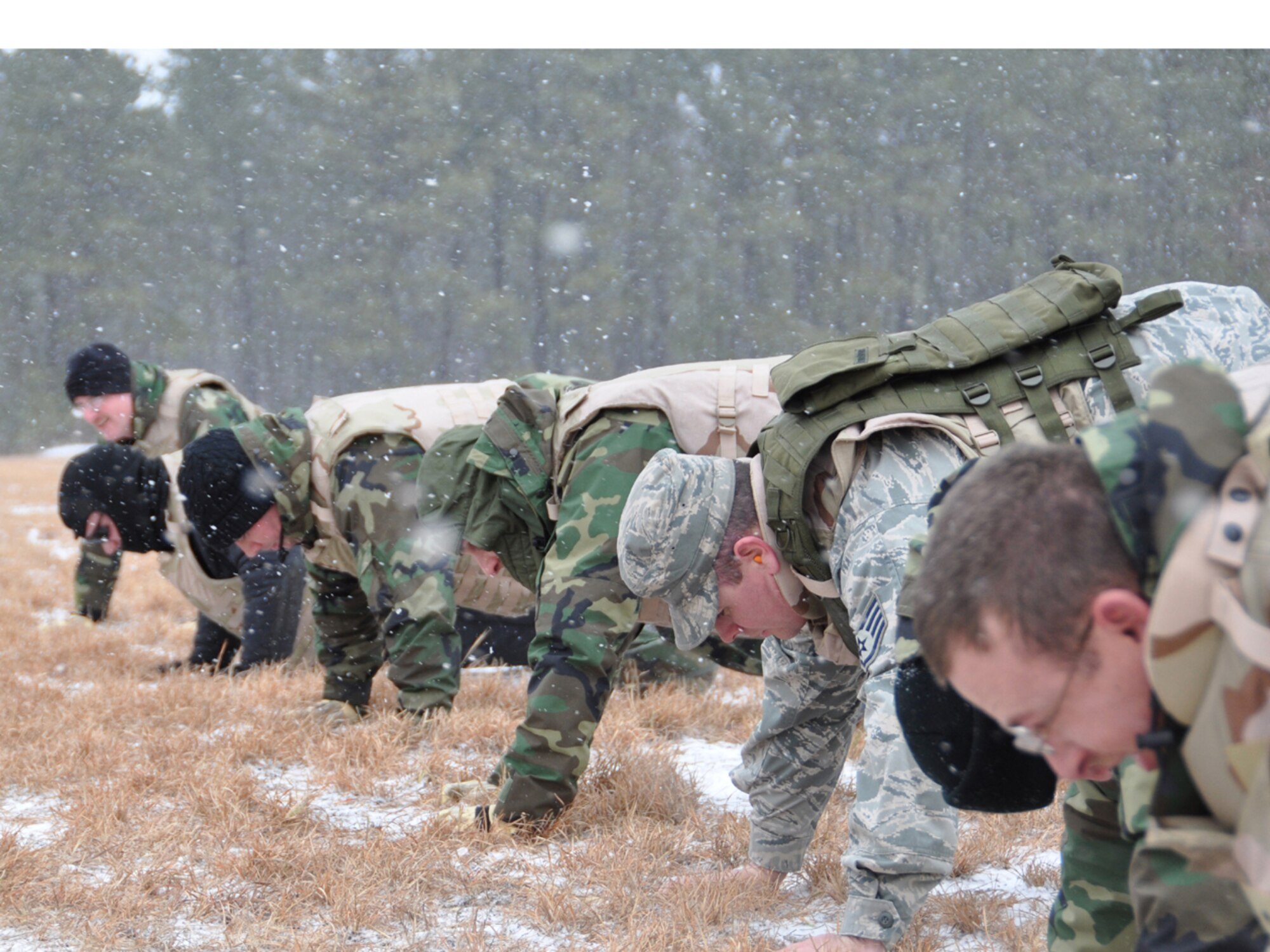 Airmen from the 818th Contingency Response Group do some "warm-up-push-ups" before the combatives training portion of the Defensive Operations Course held here, Jan 12-15. The combatives training focused on teaching the Contingency Response Airmen unarmed, hand-to-hand combat skills that may be required when deployed for contingencies. (U.S. Air Force photo/1Lt Dustin Doyle)