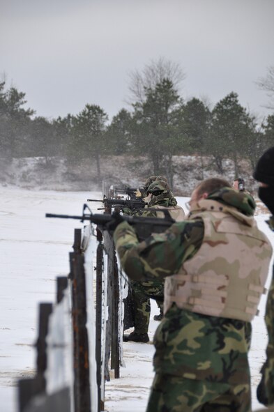 Airmen from the 818th Contigency Response Group practice shooting over barriers in a live-fire exercise during the Defensive Operations Course held here Jan. 12-15. The DOC provides force protection training to Contingency Response Wing Airmen who may be called upon to provide organic force protection when deployed to high-threat environments during contingencies. (U.S. Air Force photo/1st Lt. Dustin Doyle)