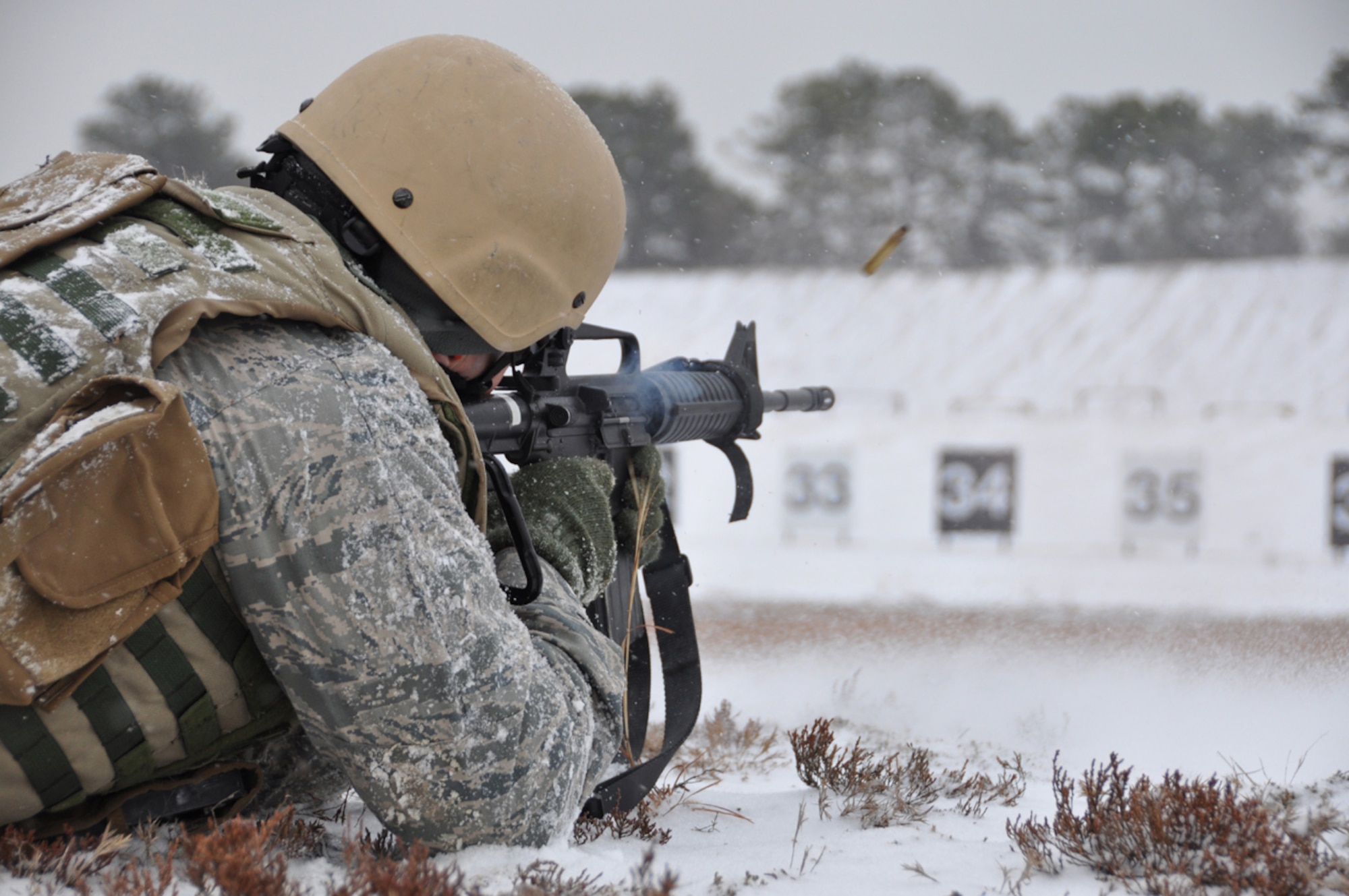 Shells fly as Capt. Joseph Michaels, an airfield manager with the 818th Contingency Response Group, shoots at his target during the live-fire portion of the Defensive Operations Course held here Jan 12-15. A member of one of the Contingency Response Wing's airfield assessment teams, Captain Michaels' job can take him into areas with minimal force protection. The DOC provides training and sharpens the skills required to act as organic force protection in high-threat situations. (U.S. Air Force photo/1Lt Dustin Doyle)