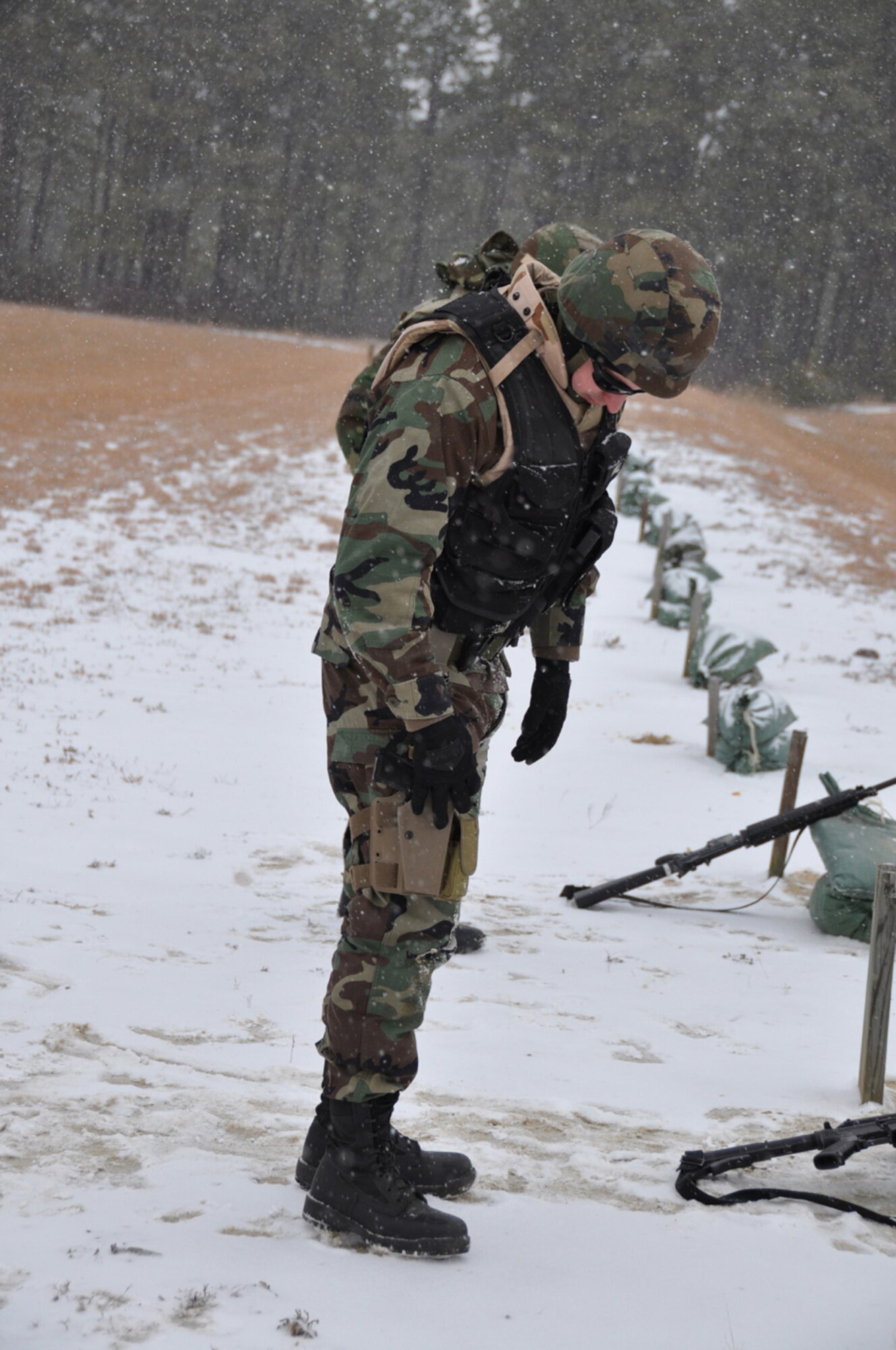 Lt. Col. Daniel Krall, 818th Global Mobility Readiness Squadron commander, holsters his M-9 for a live-fire exercise during the Defensive Operations Course held here  Jan 12-15. The DOC trains and refreshes Contingency Response Wing Airmen on the skills required to provide organic force protection when the CRW deploys to non-permissive environments during contingencies. (U.S. Air Force photo/1Lt Dustin Doyle)