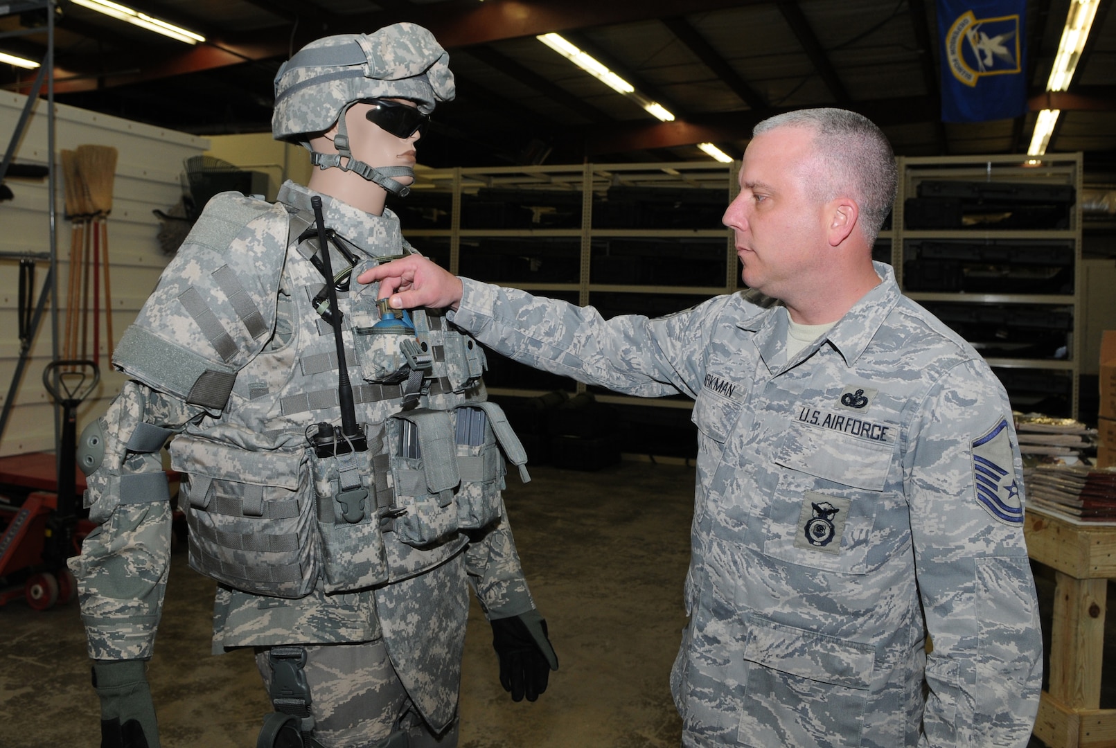 Master Sgt. George Barkman inspects a full issue of gear that is given to all deploying security forces personnel. Sergeant Barkman received an Air Force level award that cited his leadership and organizational qualities. (U.S. Air Force photo by Rich McFadden)