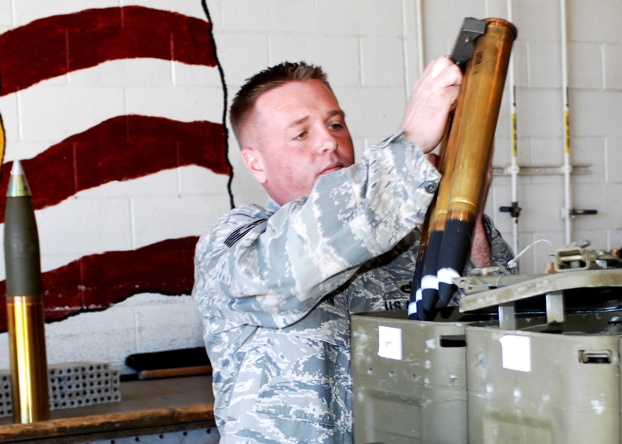 CANNON AIR FORCE BASE, N.M. -- Tech. Sgt. Chris Cochran, 27th Special Operations Equipment Maintenance Squadron, offloads 40 mm rounds, part of a routine for the NCOIC munitions inspector. Sergeant Cochran was selected to represent  Air Force Special Operations Command at the Air Force level for the General Leo Marquez Award. The award recognizes Airmen who demonstrate the highest degree of sustained job performance, knowledge and efficiency. (Air Force photo by Greg Allen)