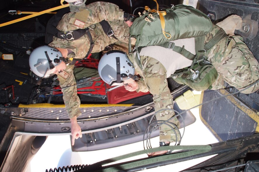 Tech. Sgts Joe Robles (kneeling) and Tech. Sgt. Sean Kirsch spot the parachute landing zone while on a mission on an HC-130P combat search and rescue aircraft at Camp Lemonier, Djibouti, Jan. 10. Both men are deployed from the 131st Rescue Squadron at Moffett Federal Airfield, Calif. Camp Lemonier is the hub of the Combined Joint Task Force, Horn of Africa, providing humanitarian relief, security and anti-terrorism activities to the nations in the Horn of Africa. (U.S. Air Force photo by Tech. Sgt. Joe Zuccaro)