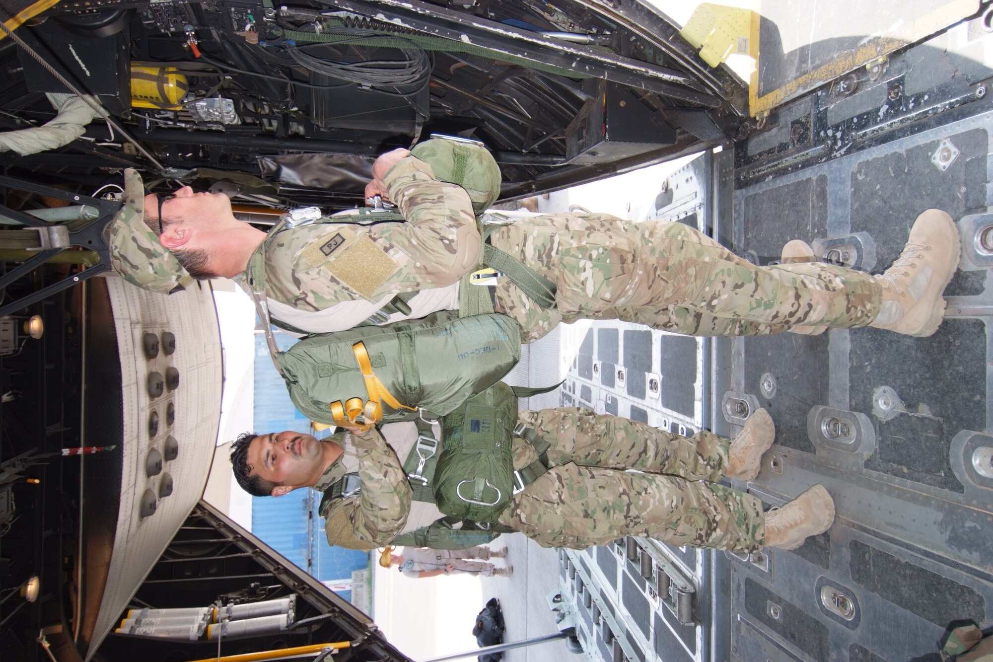 Tech. Sgt. Joe Robles performs a safety check of a parachute on Tech. Sgt. Sean Kirsch, both deployed prior to a mission on an HC-130P combat search and rescue aircraft at Camp Lemonier, Djibouti, Jan. 10. Both men are deployed from the 131st Rescue Squadron at Moffett Federal Airfield, Calif. Camp Lemonier is the hub of the Combined Joint Task Force, Horn of Africa, providing humanitarian relief, security and anti terrorism activities to the nations in the Horn of Africa. (U.S. Air Force photo by Tech. Sgt. Joe Zuccaro)