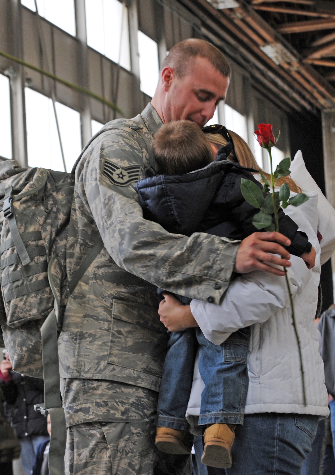 MOUNTAIN HOME AIR FORCE BASE, Idaho - Staff Sgt John Corley, 726th Air Control Squadron, hugs his family upon his return from Iraq on Jan. 17.  More than 170 members of the 726th Air Control Squadron returned to Mountain Home on Jan. 17 following nearly five months of combat duty in Iraq. In addition, 12 F-15E Strike Eagles along with aircrews and maintenance teams with the 391st Fighter Squadron also returned here Jan. 17 following a four-month deployment to Bagram Air Base, Afghanistan.  (U.S. Air Force photo/Airman 1st Class Renishia R. Richardson) 
