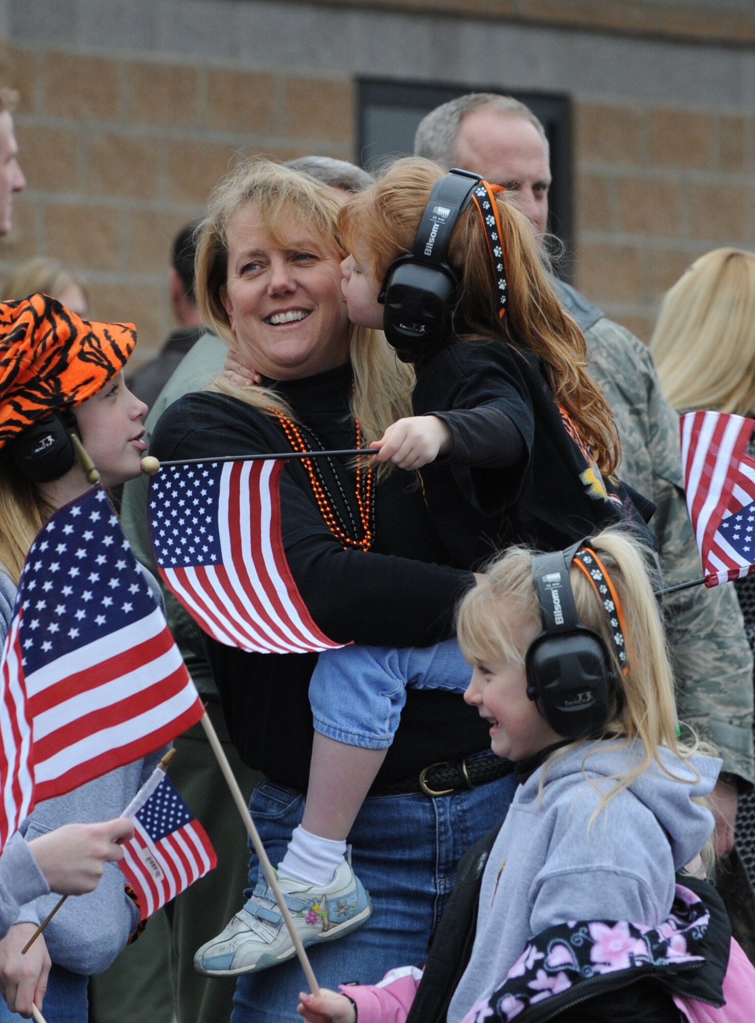 MOUNTAIN HOME AIR FORCE BASE, Idaho - Colby Orcutt kisses her mother, Terry, as they await the arrival of Lt. Col. Daniel Orcutt, 391st Fighter Squadron commander, on the base flightline Jan. 17 following the colonel’s four-month deployment to Afghanistan.  Twelve 12 F-15E Strike Eagles, along with aircrews and maintenance teams with the fighter squadron, returned here that day following a four-month deployment to Bagram Air Base, Afghanistan.  In addition, more than 170 members of the 726th Air Control Squadron returned to Mountain Home that afternoon following nearly five months of combat duty in Iraq.  (U.S. Air Force photo/Airman 1st Class Renishia R. Richardson) 