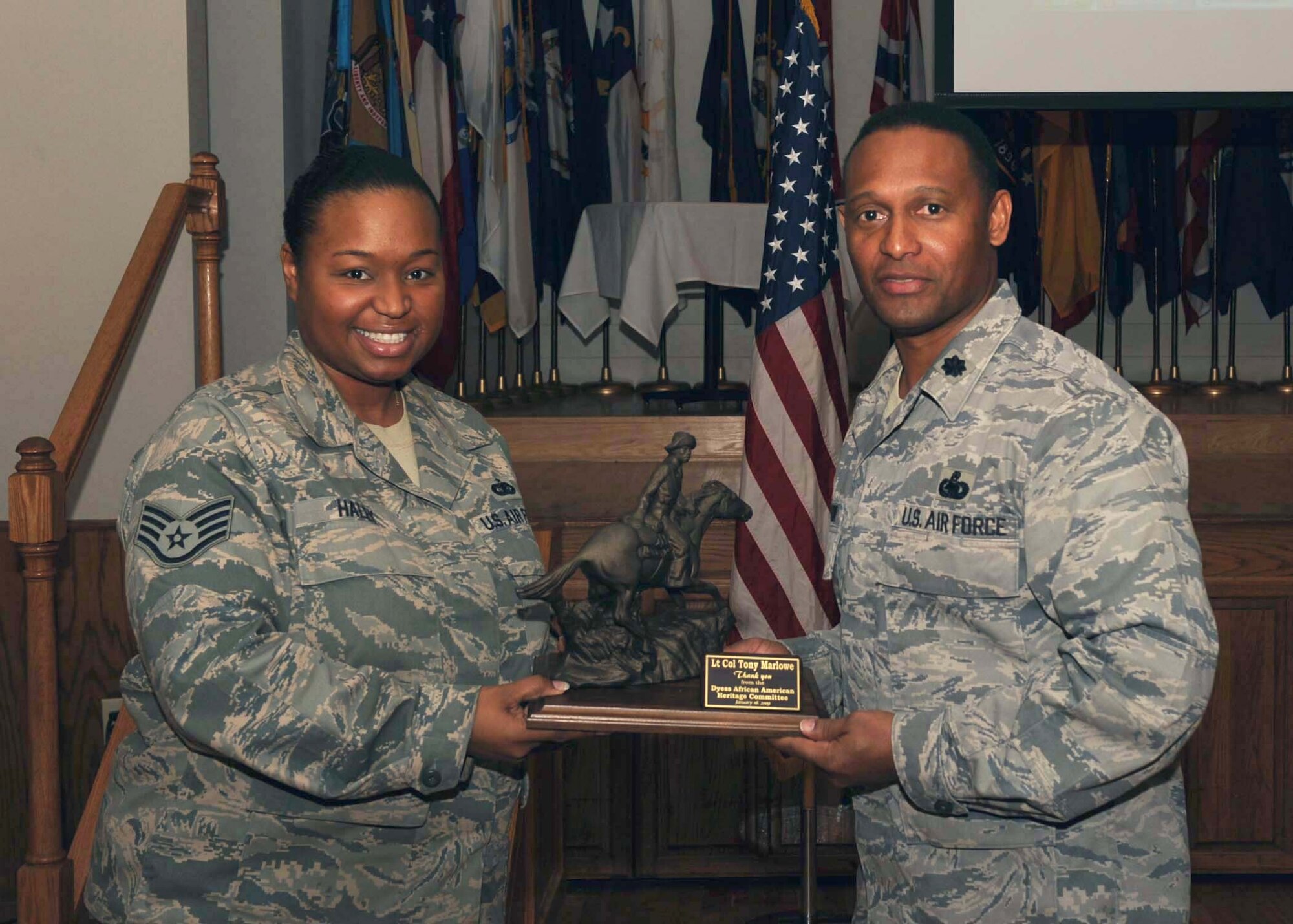 DYESS AIR FORCE BASE, Texas -- Staff Sgt. Sparkle Haley presents a memento to Lieutenant Colonel Tony Marlowe, the guest speaker during the Dr. Martin Luther King, Jr. luncheon here, Jan. 16. The award was given by the Dyess African American Heritage Committee to Colonel Marlowe in appreciation for being the guest speaker. (U.S. Air Force photo by Airman 1st Class Stephen Reyes)