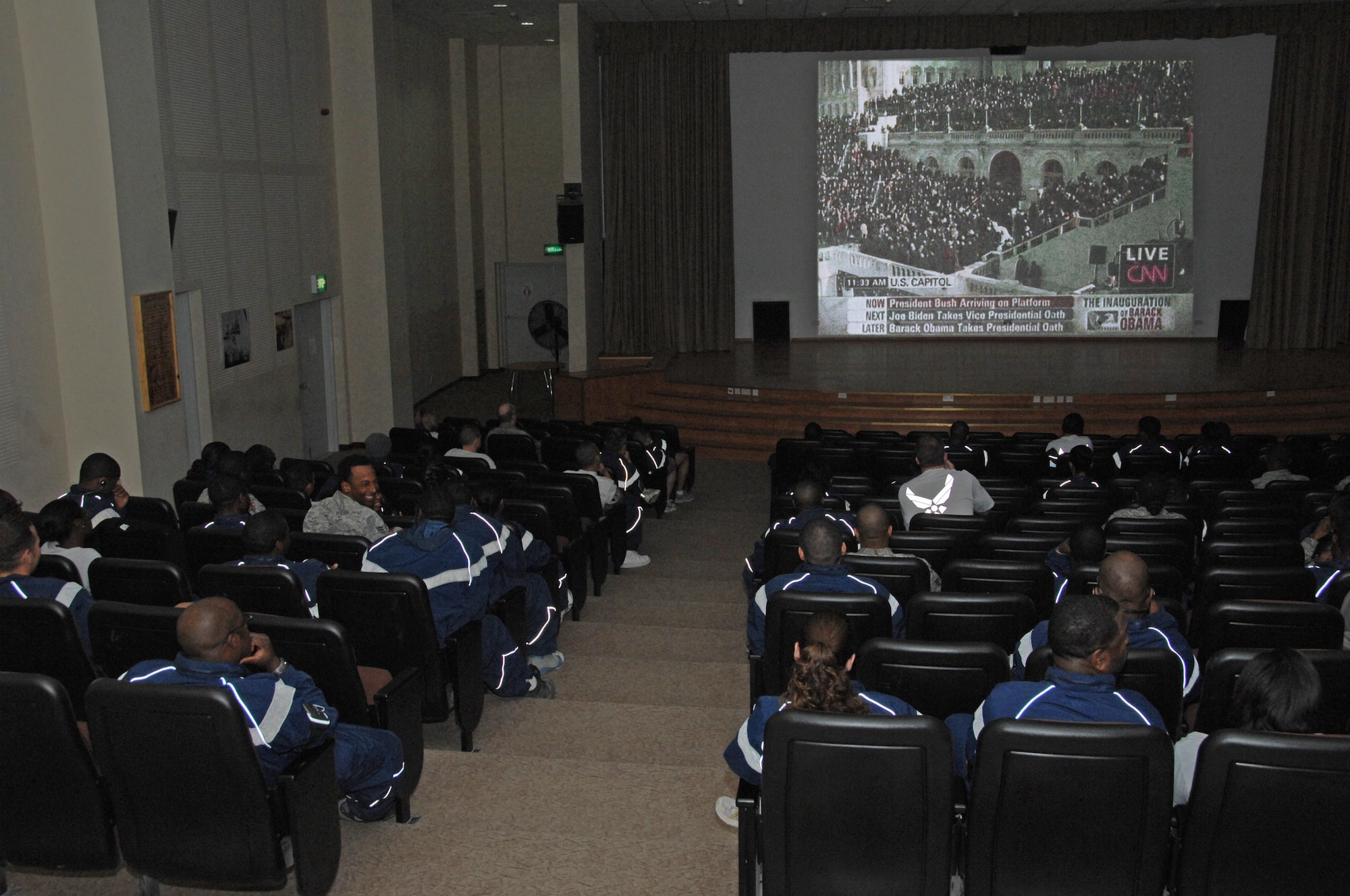 Members of the 386th Air Expeditionary Wing come together to watch the inauguration ceremony of President Barack Obama and Vice President Joe Biden Jan. 20 in the theater at an air base in Southwest Asia. (U.S. Air Force photo/Senior Airman Courtney Richardson) 
